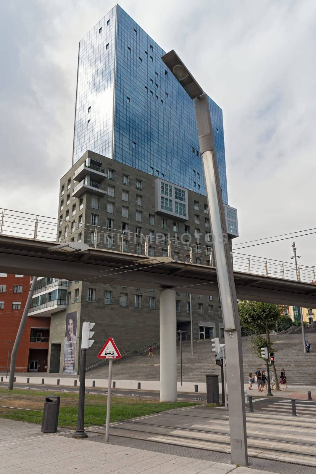 pedestrians below the Isozaki towers in bilbao spain