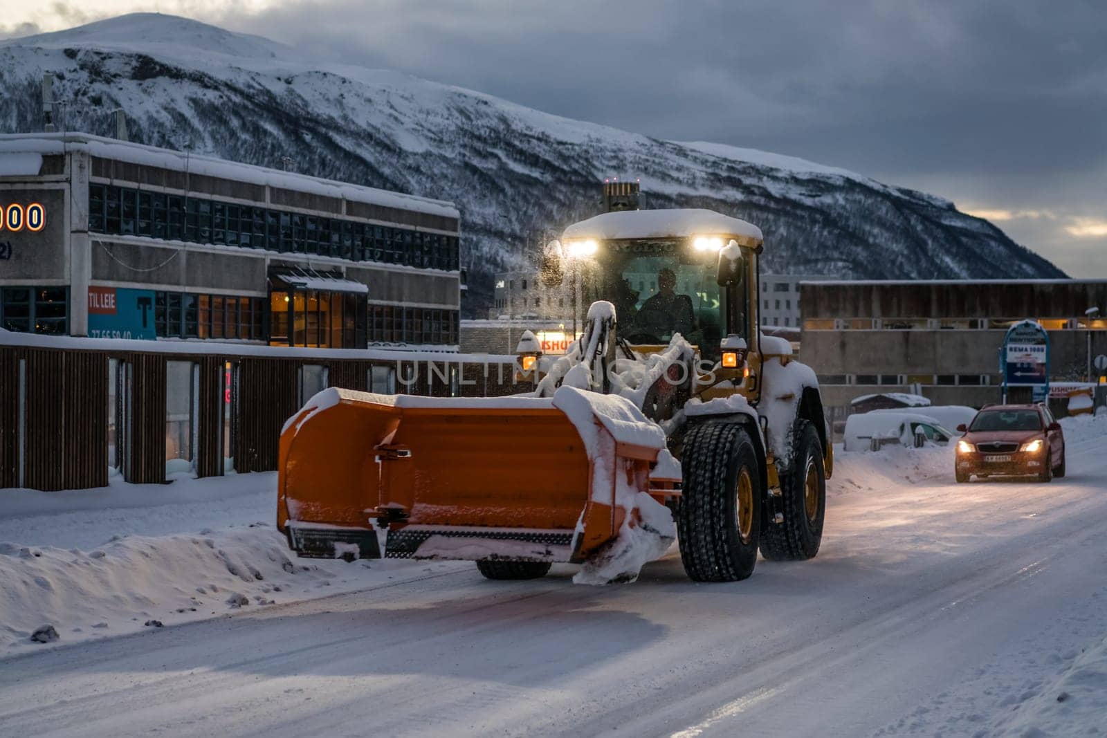 Tromso, Norway -  December 2018 : Powerful snowplough clearing residential roads in Tromso town in winter