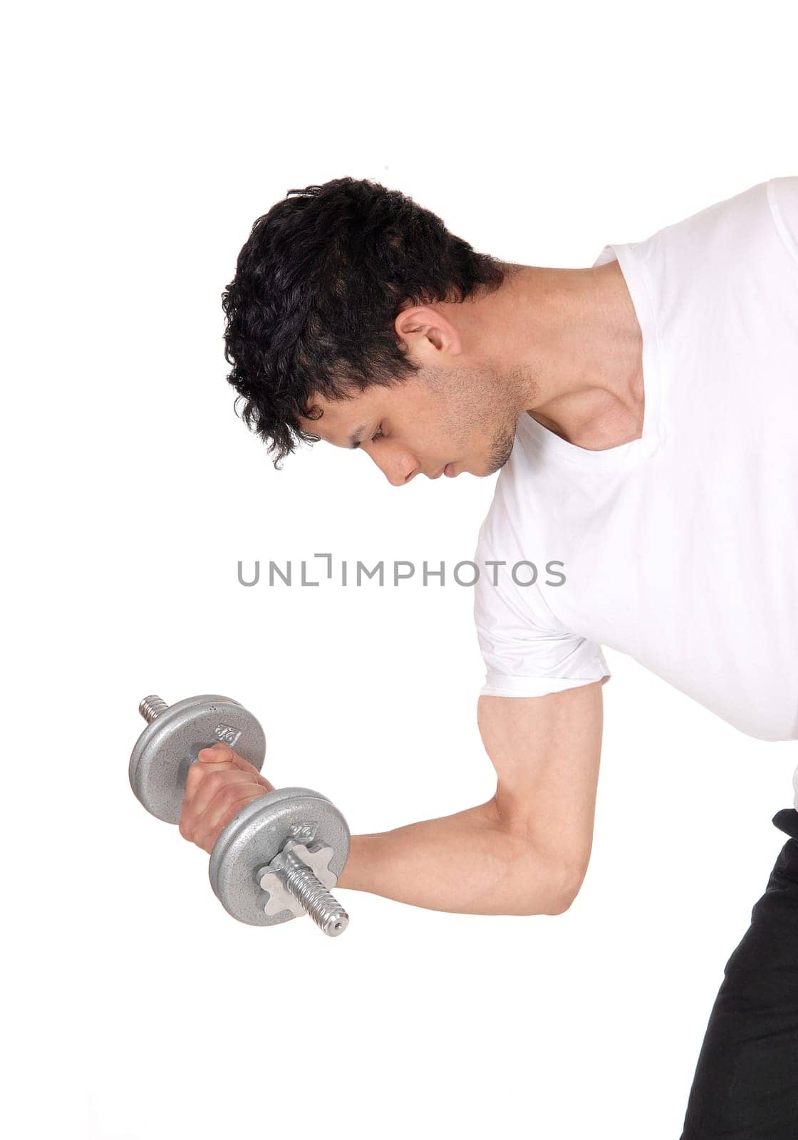 A handsome young man standing in the studio exercising with his .dumbbells, waist up and close up, isolated for white background.