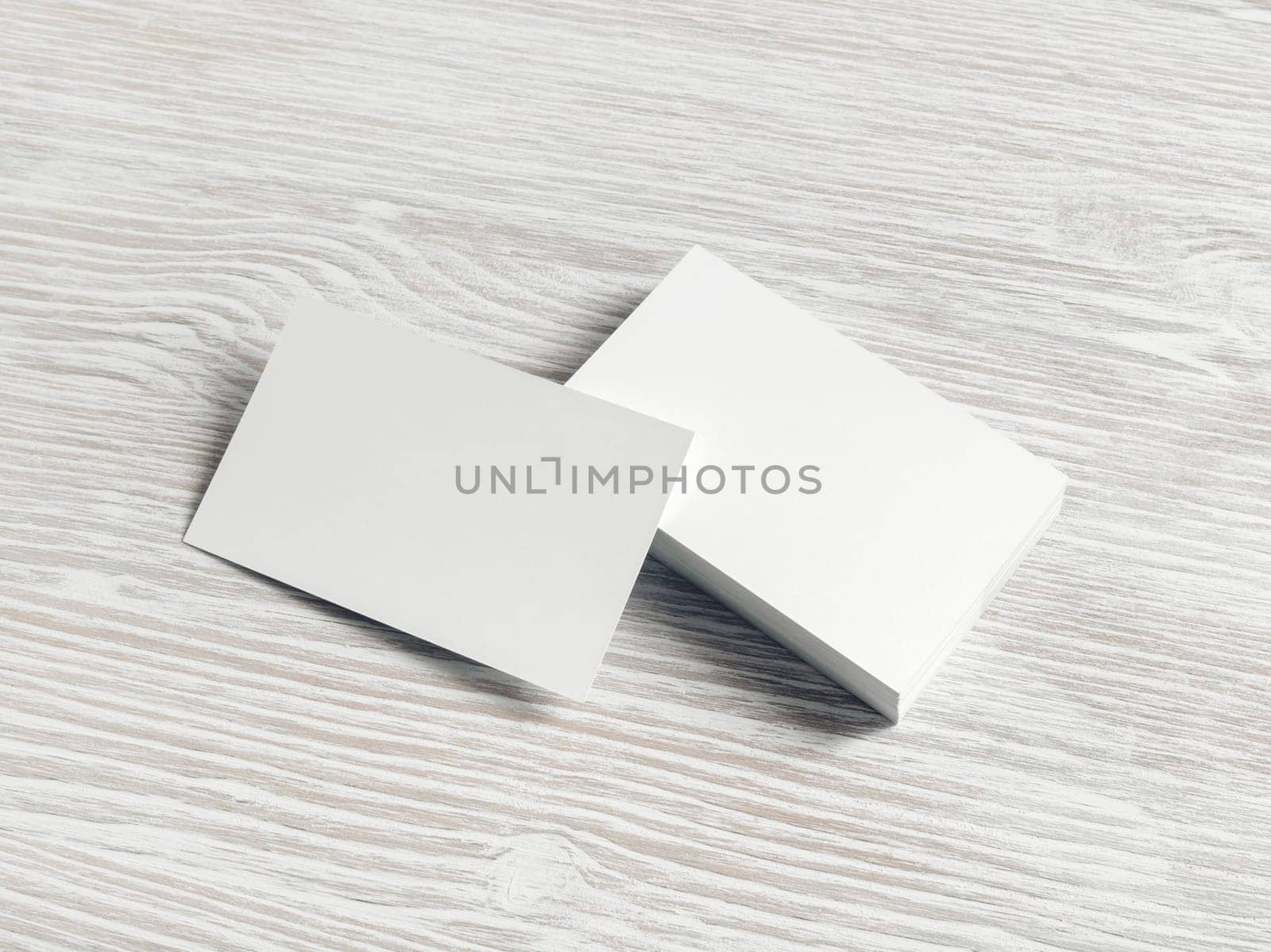 Photo of blank white business cards on light wood table background. Copy space for text.