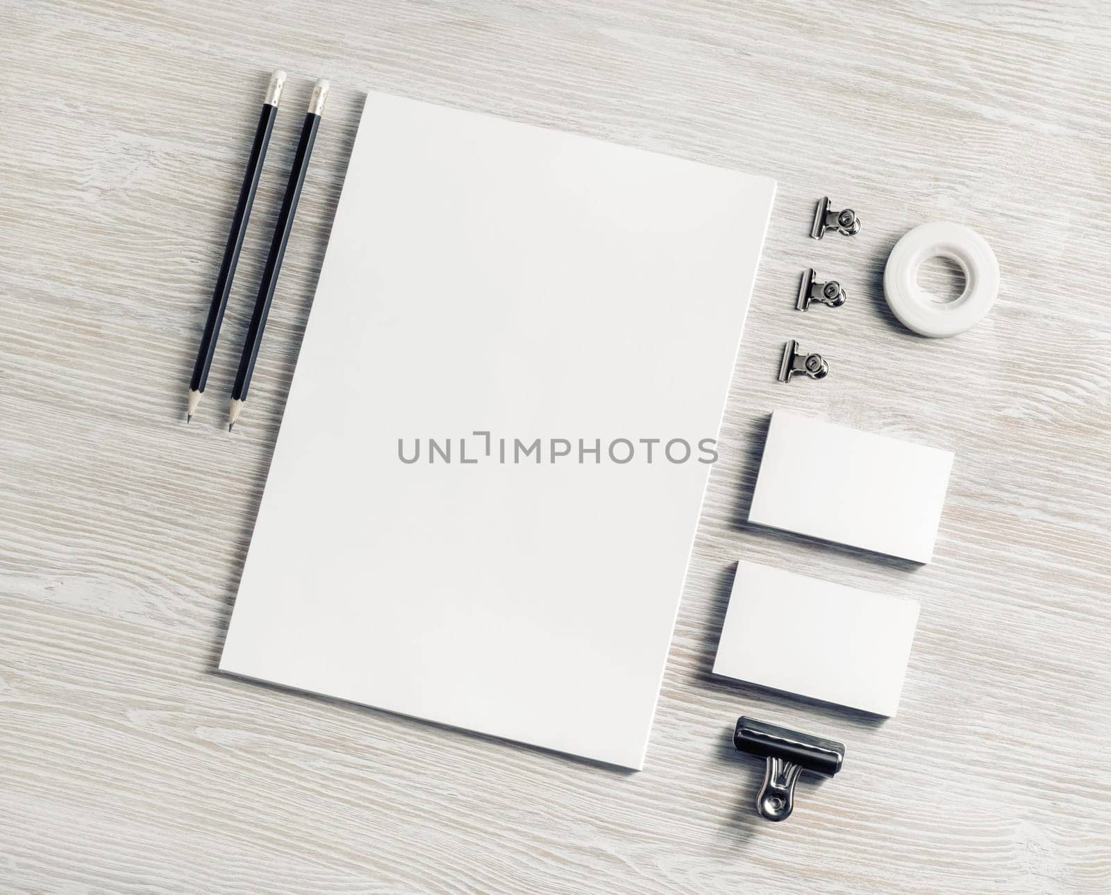 Blank branding stationery set on light wood table background. Corporate stationery template. Flat lay.