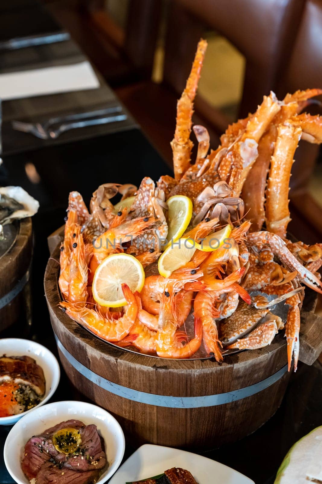 Variety of seafood on ice serve in wooden bucket