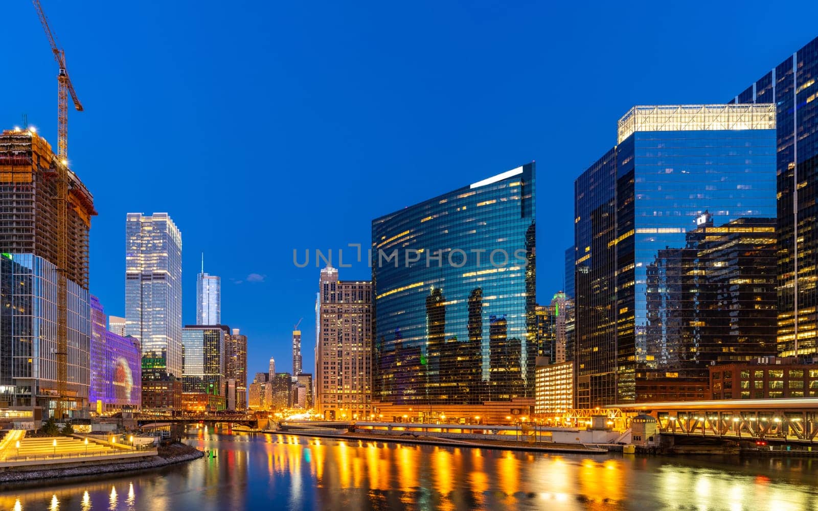 Panorama shot of City of Chicago downtown and Chicago River sunset night in Chicago Illinois USA.