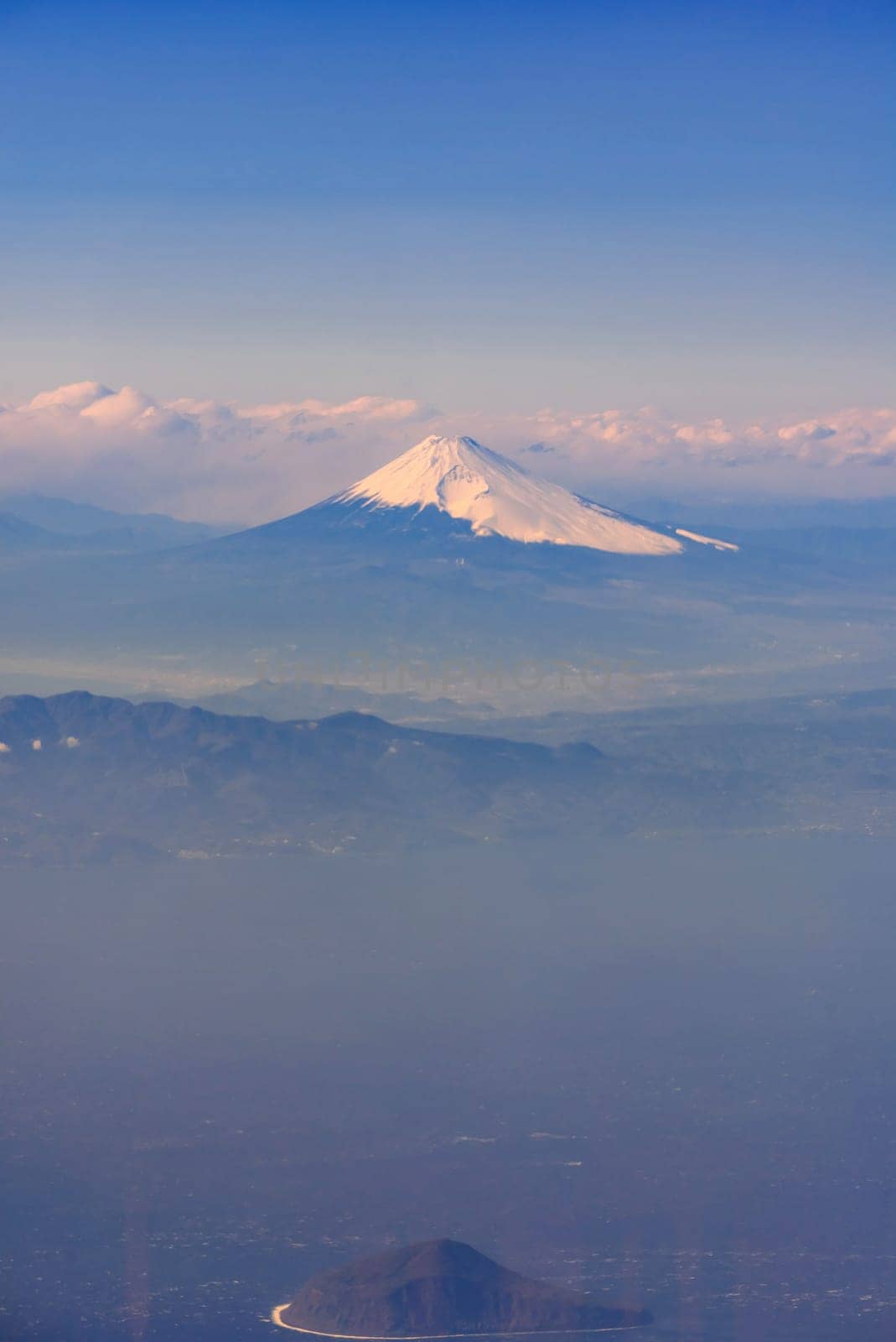 Aerial view of Fuji san, Mountain Fuji, landmark mountain of Japan. Take from Airplane while fly pass Fuji City Shizuoka Japan