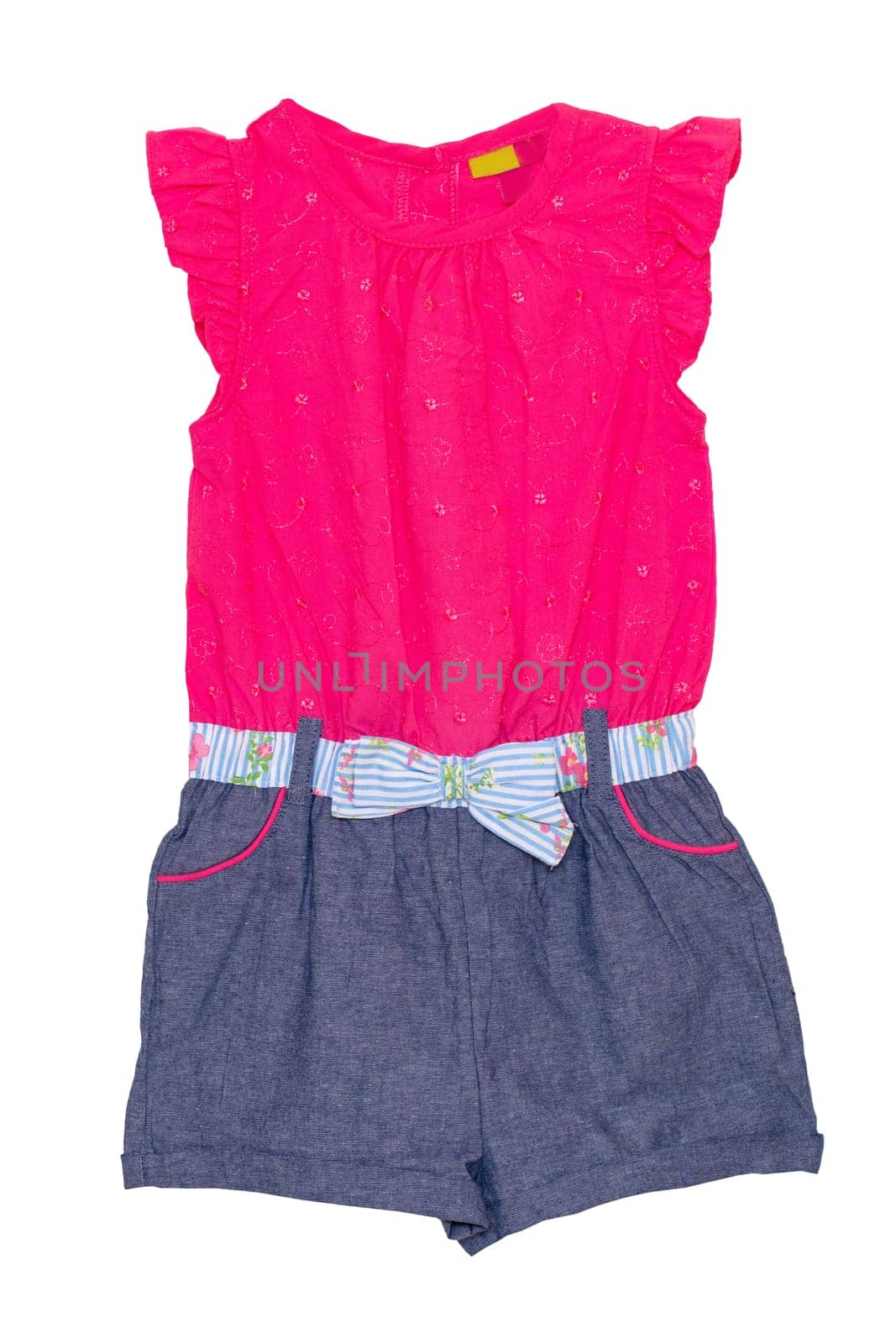 Jumpsuit isolated. Closeup of a stylish sleeveles pink blue denim jumpsuit with a clorful ribbon bow isolated on a white background. Childs fashion.