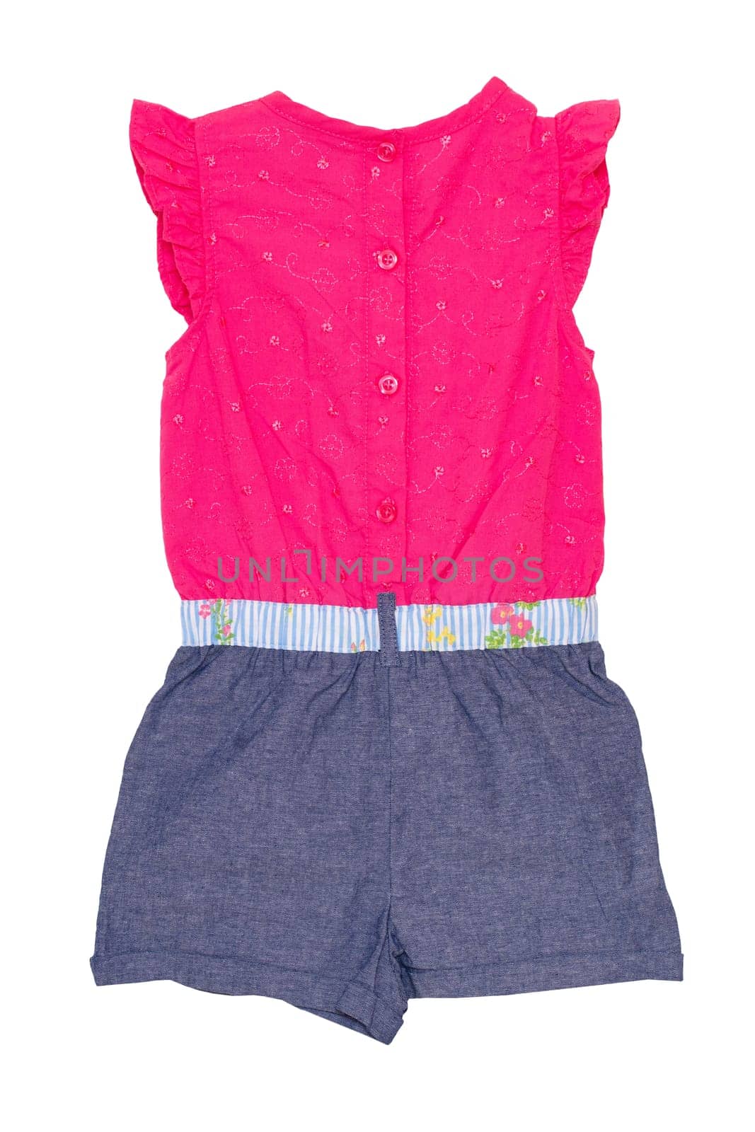Jumpsuit isolated. Closeup of a stylish sleeveles pink blue denim jumpsuit with a clorful ribbon bow isolated on a white background. Childs fashion.