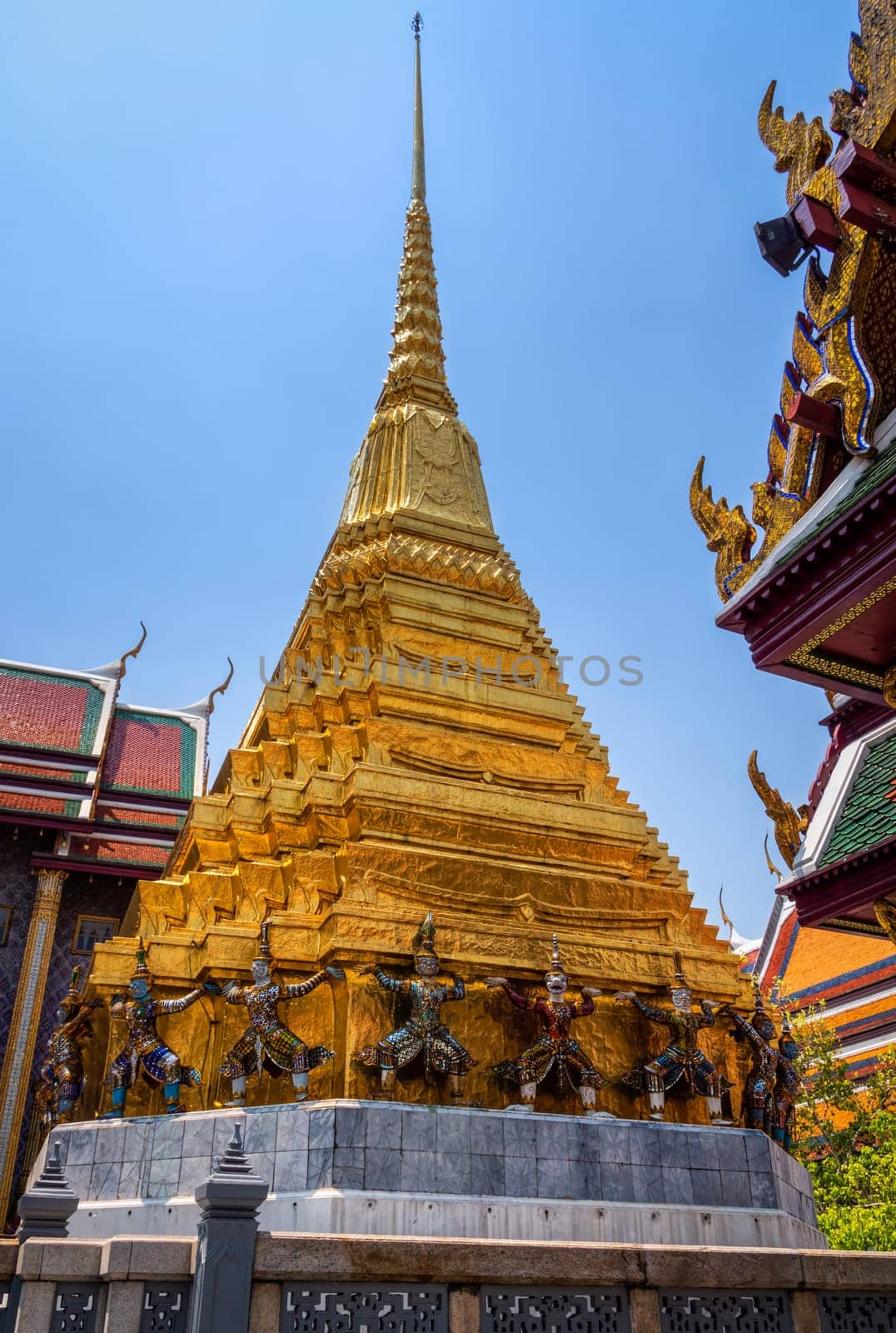 Beautiful Giant statues at the base of Gold pagoda in Wat Pra Kaew in The Grand Palace, Bangkok