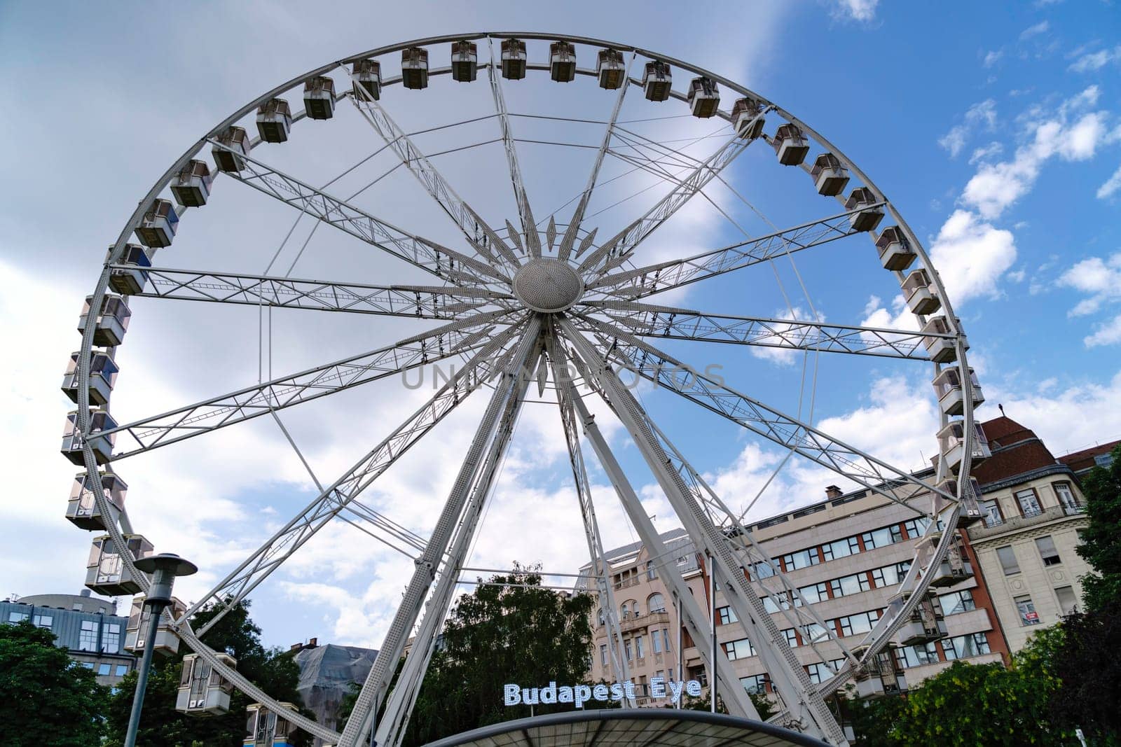 Budapest, Hungary - July 05, 2019: Luminous Ferris wheel in night city. Budapest Eye at night. Sziget Eye. The new Ferris Wheel opened on Erzsébet Square in mid-march 2017 and it will operate throughout the year.