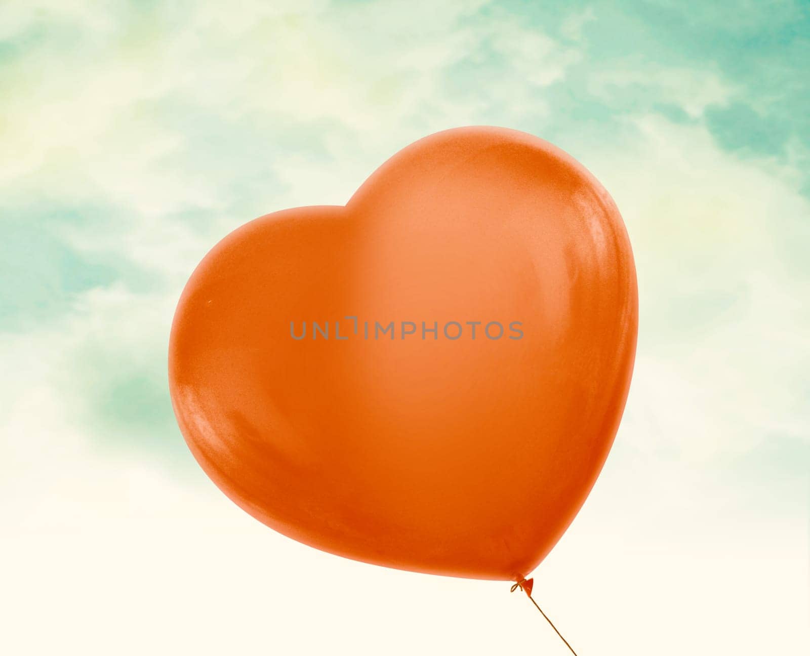 Red love heart balloon in vintage blue sky with clouds, clipping path and alpha channel included.