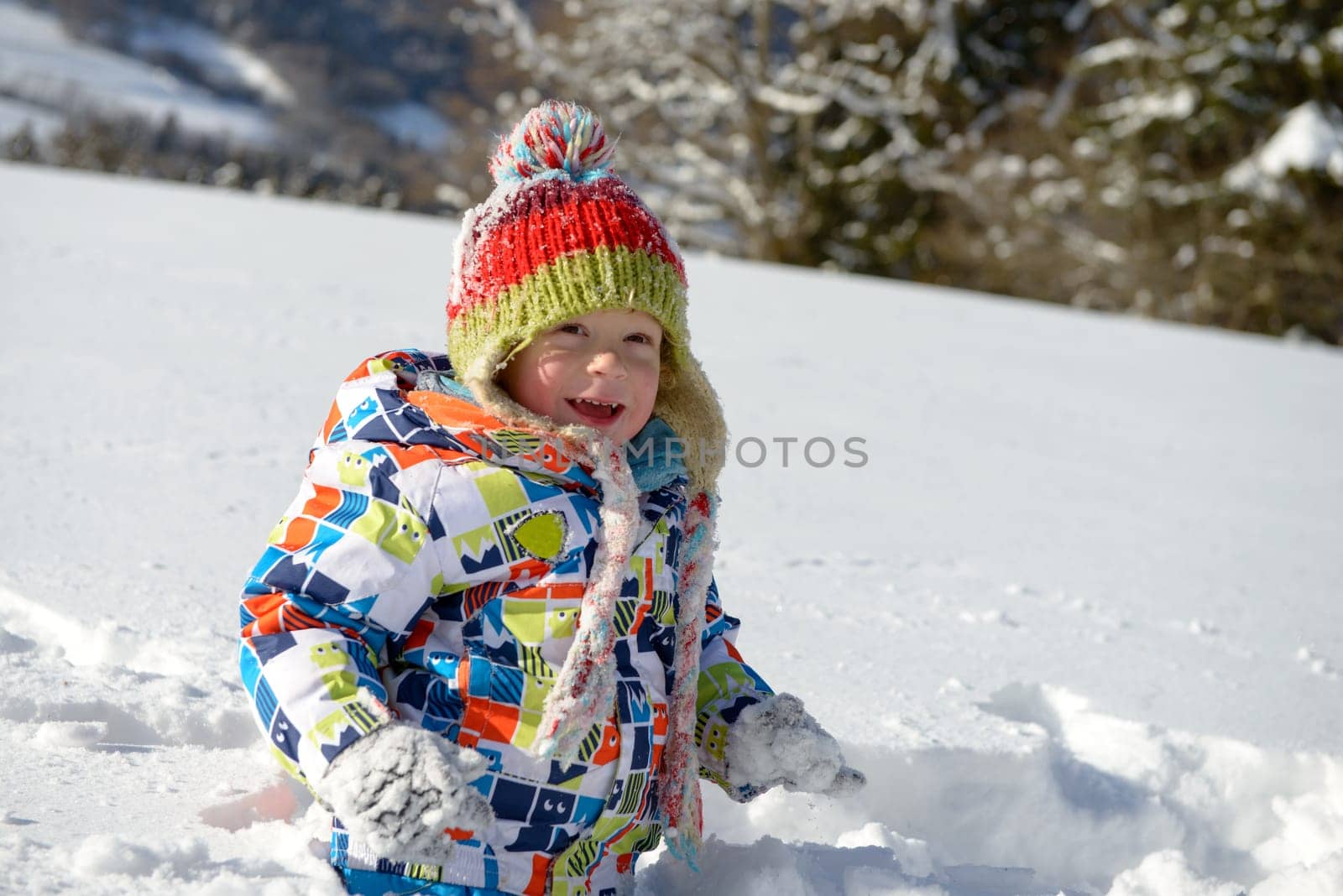 little 3 year old child playing in the snow