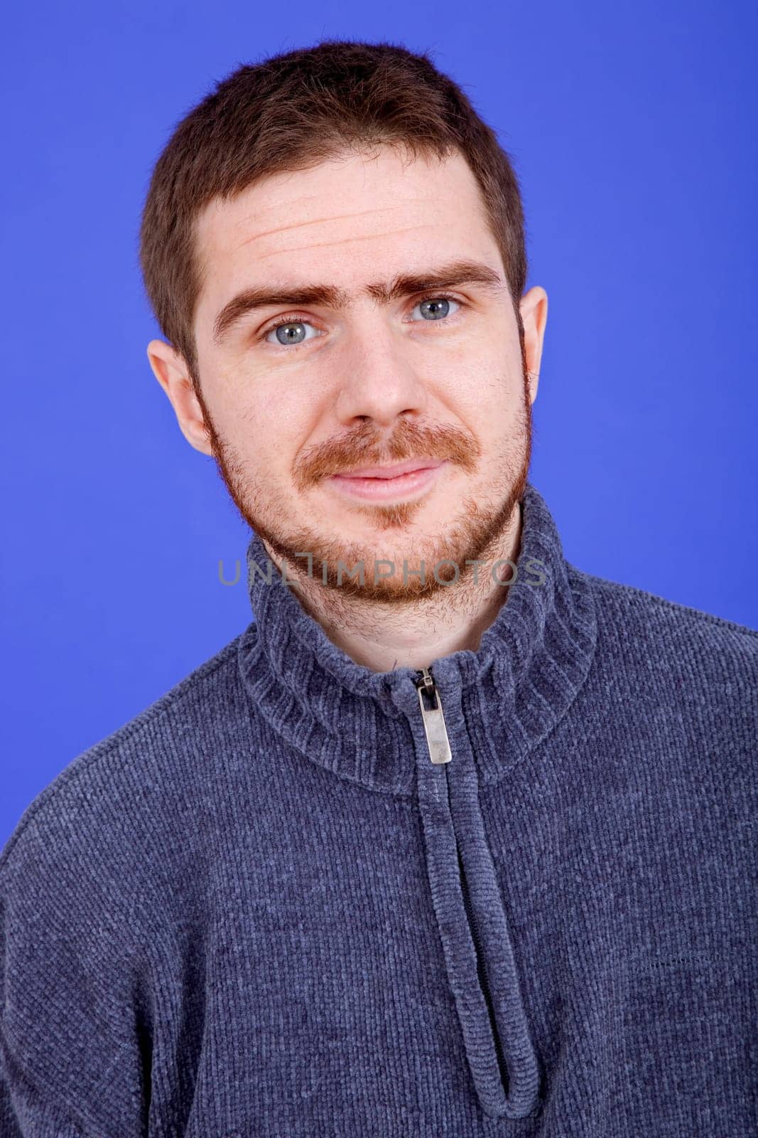 an young man portrait over a blue background