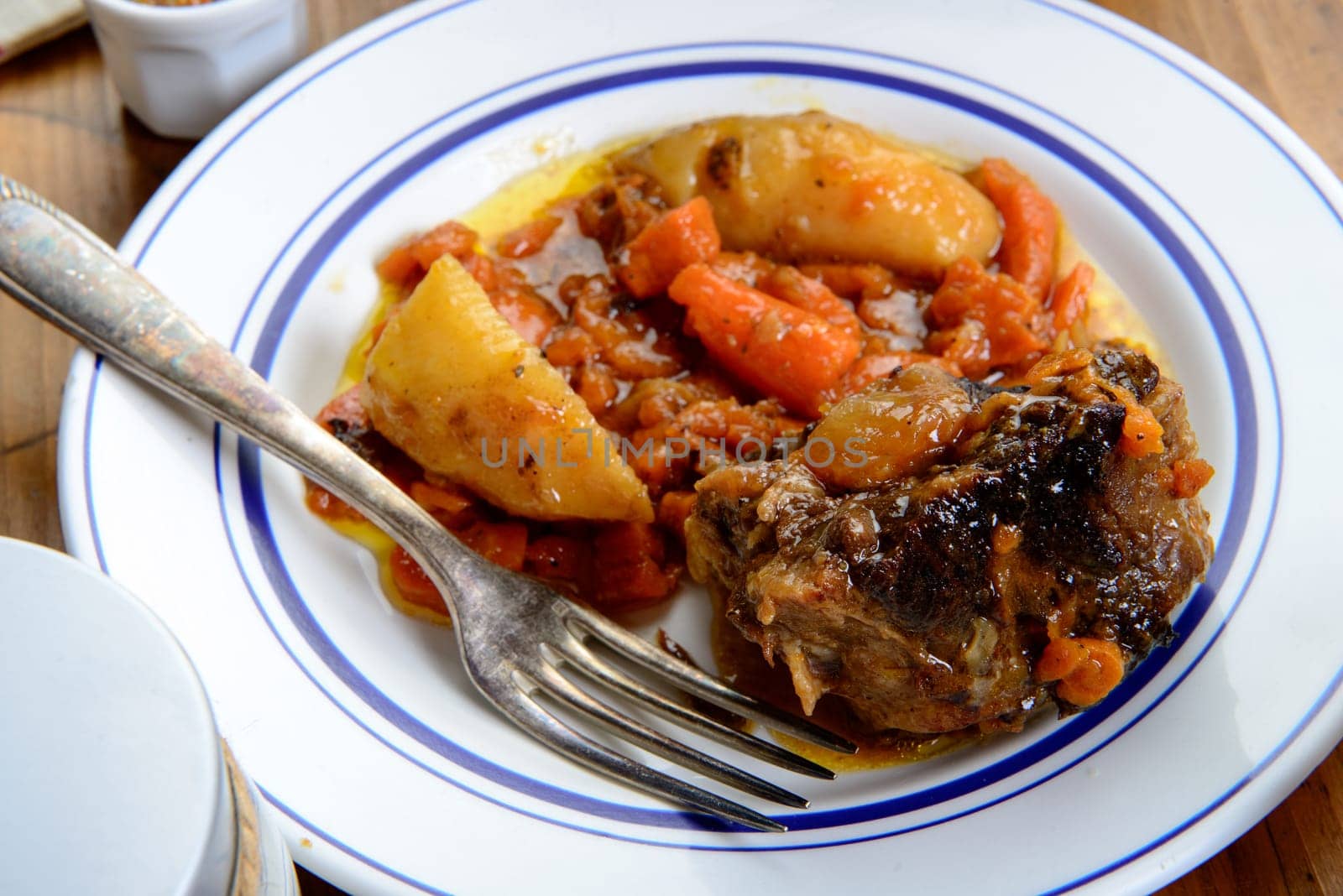 dish with beef carrots and potatoes on table