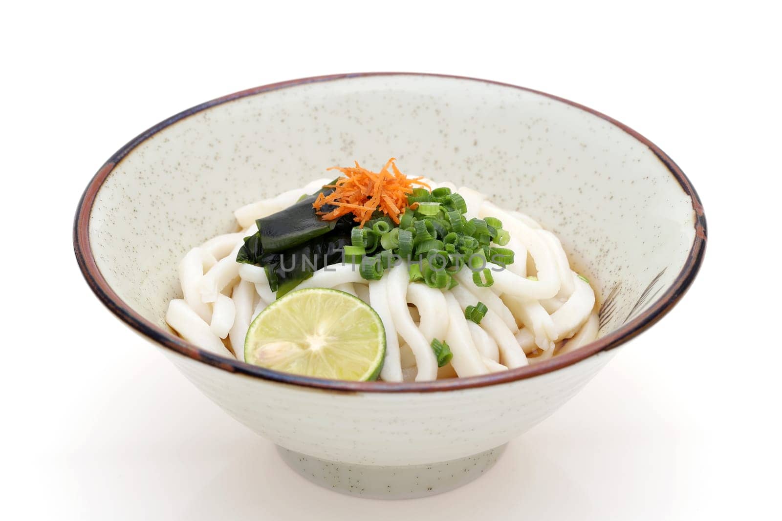 Japanese bukkake udon noodles in a ceramic bowl on white background