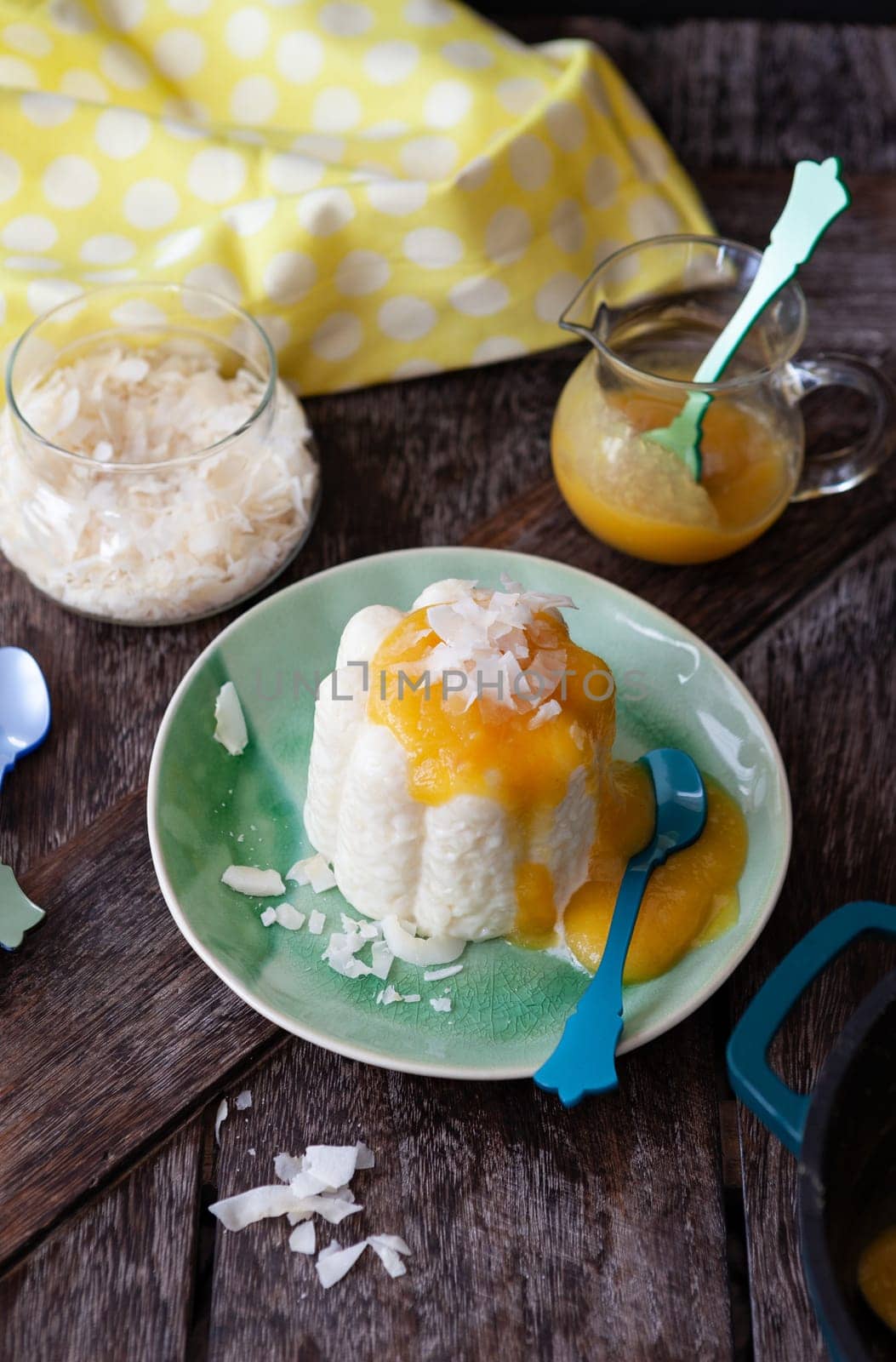 Exotic vegan rice pudding with coconut and mango sauce
