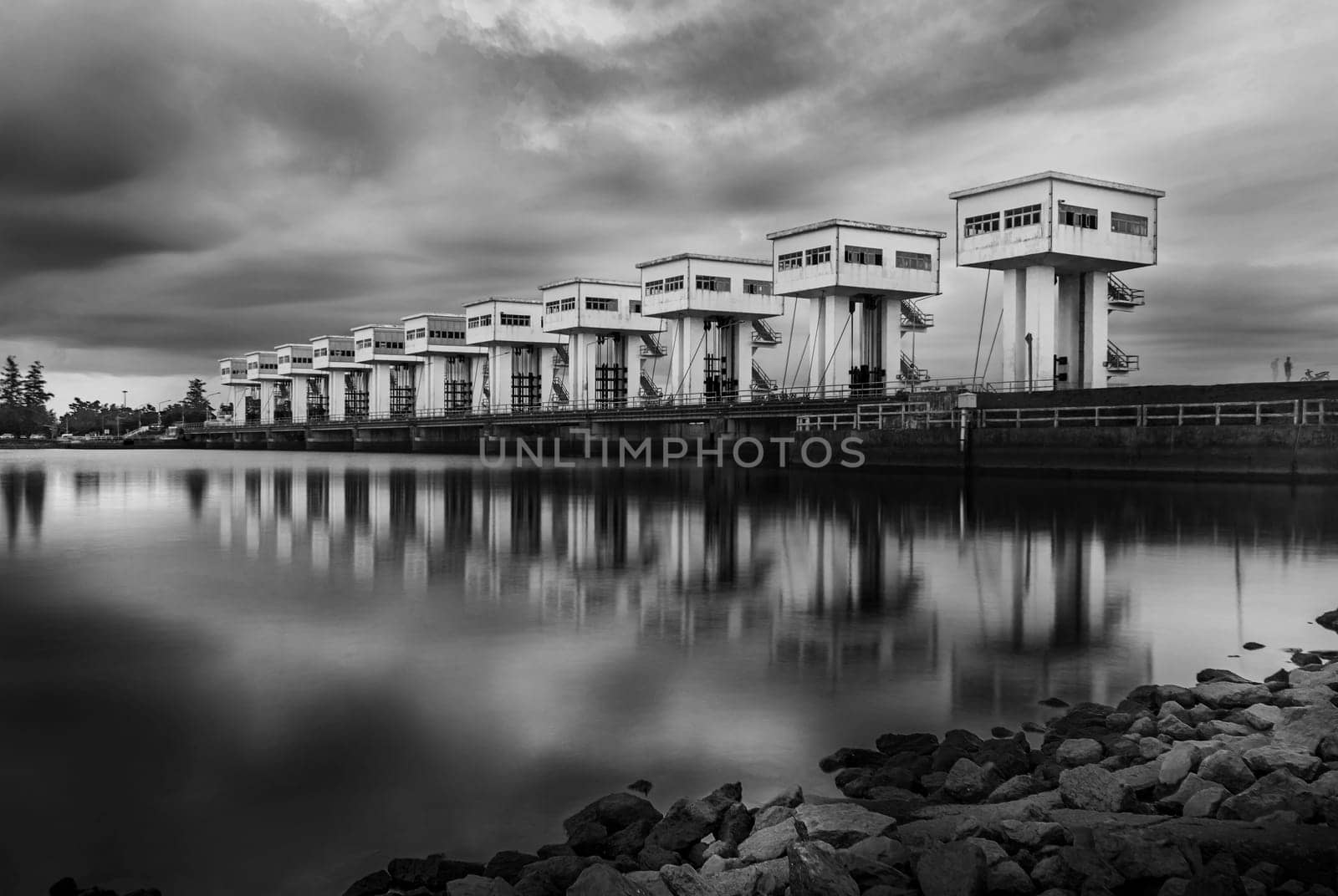 Water barrier with cloud sky in sunset and river long exposure style, Black and white and monochrome style