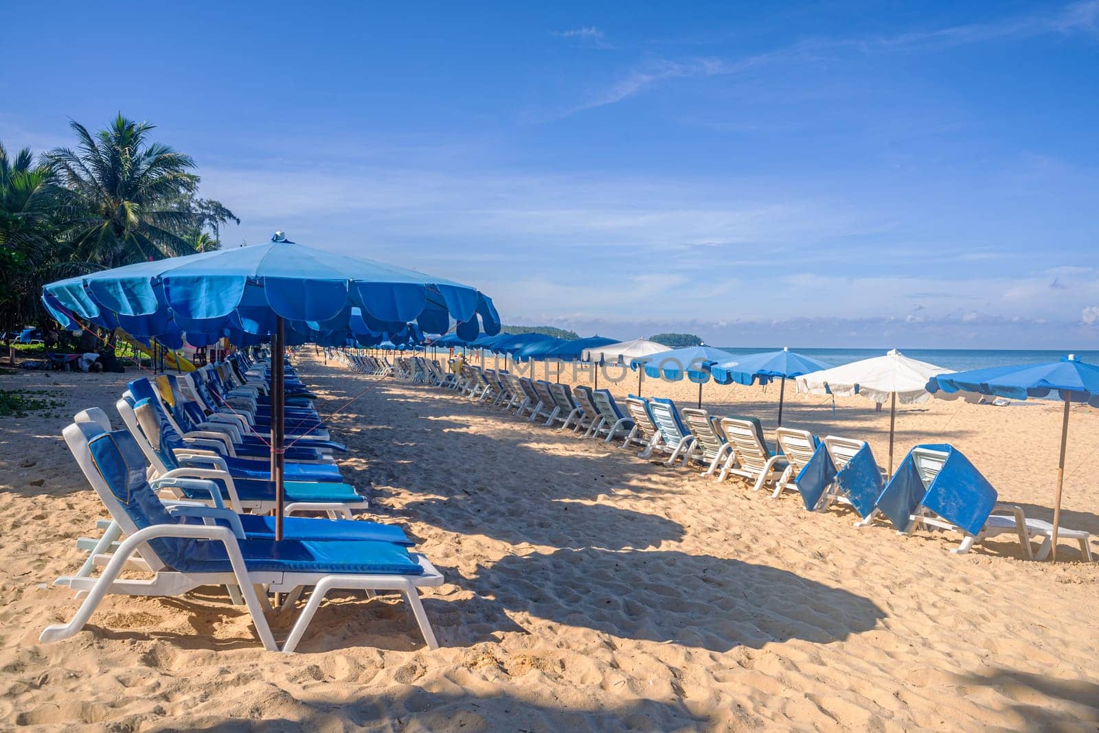Beach with umbrella and white sand and blue sea and blue sky and white cloud sunny in holiday summer season