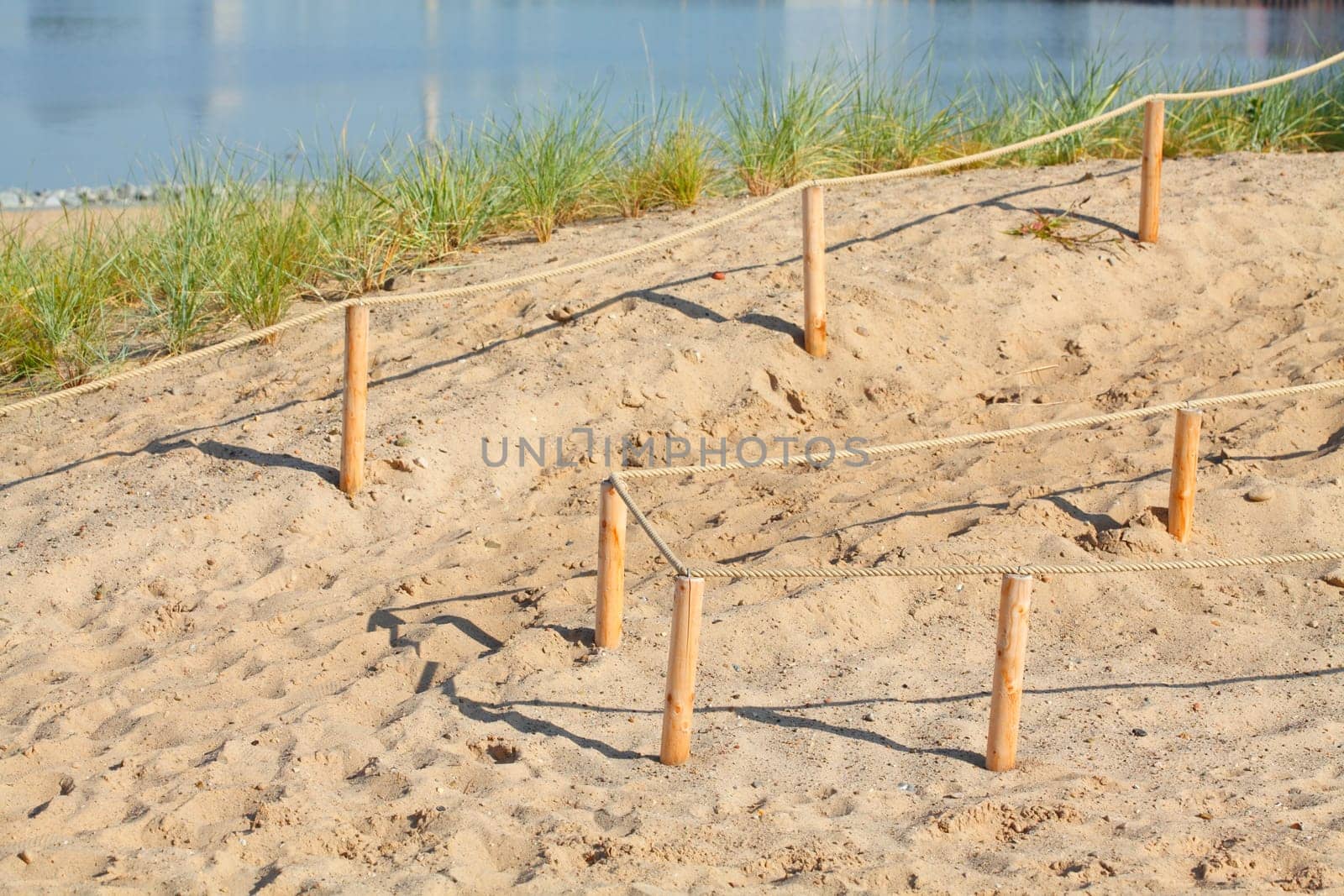 Sand dunes with path and fence, Germany, Europe..