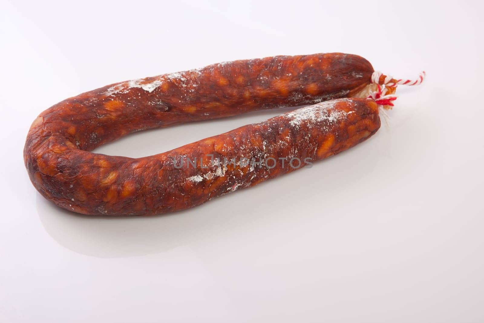 Red spanish chorizo sausage. Isolated over white background