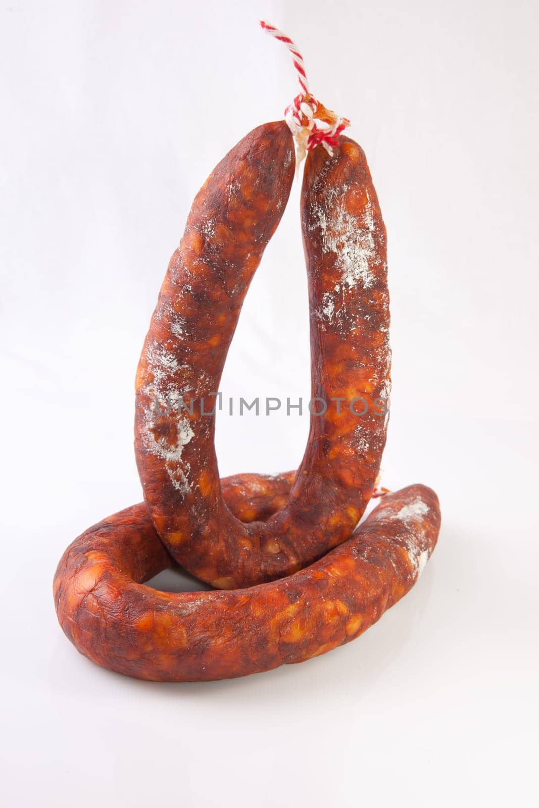 Two red spanish chorizos. Isolated over white background