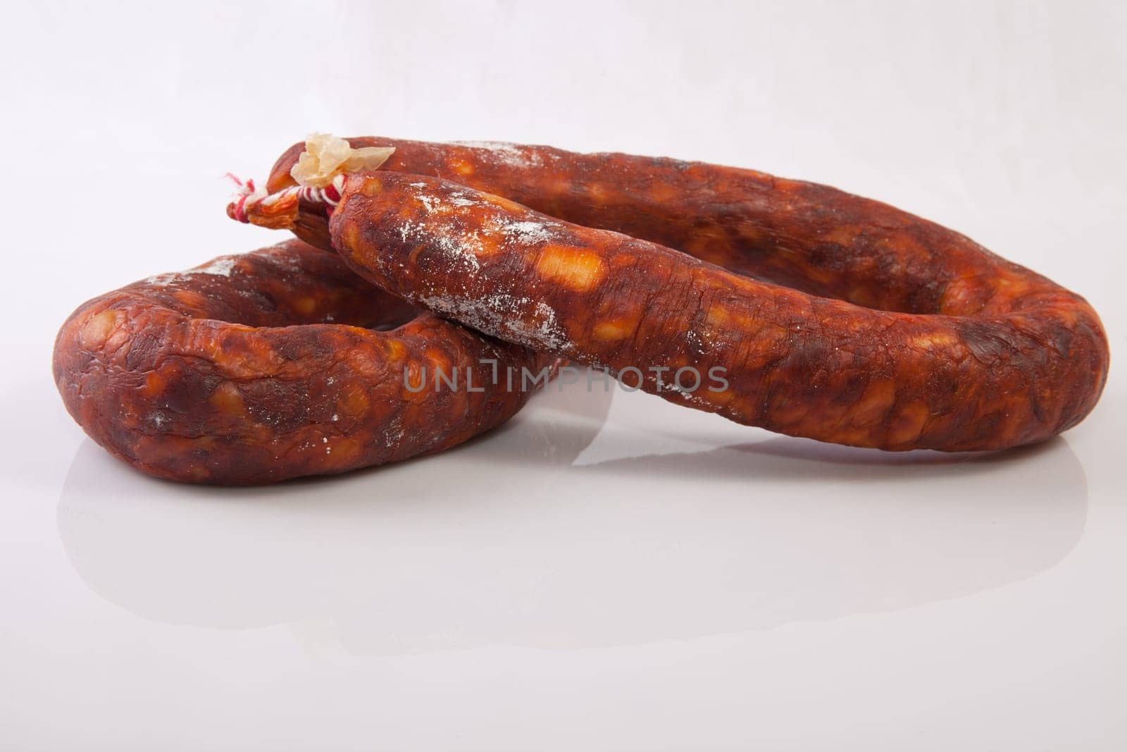 Two red spanish chorizos. Isolated over white background