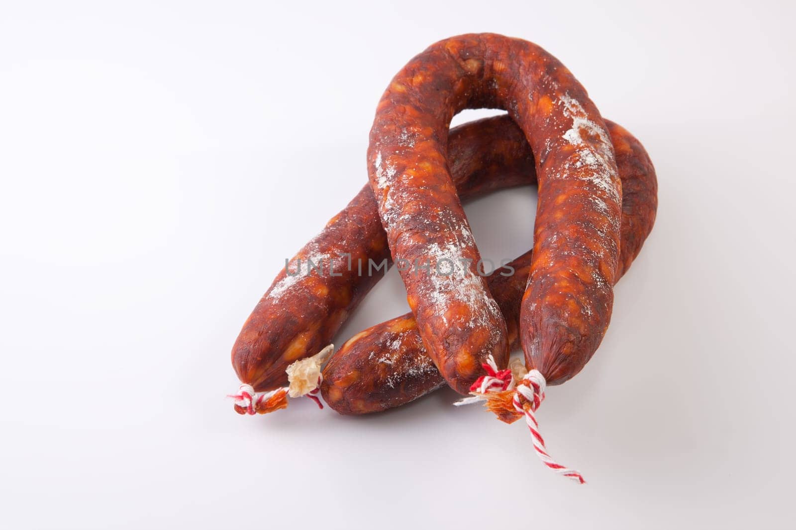Two red spanish chorizos. Isolated over white background