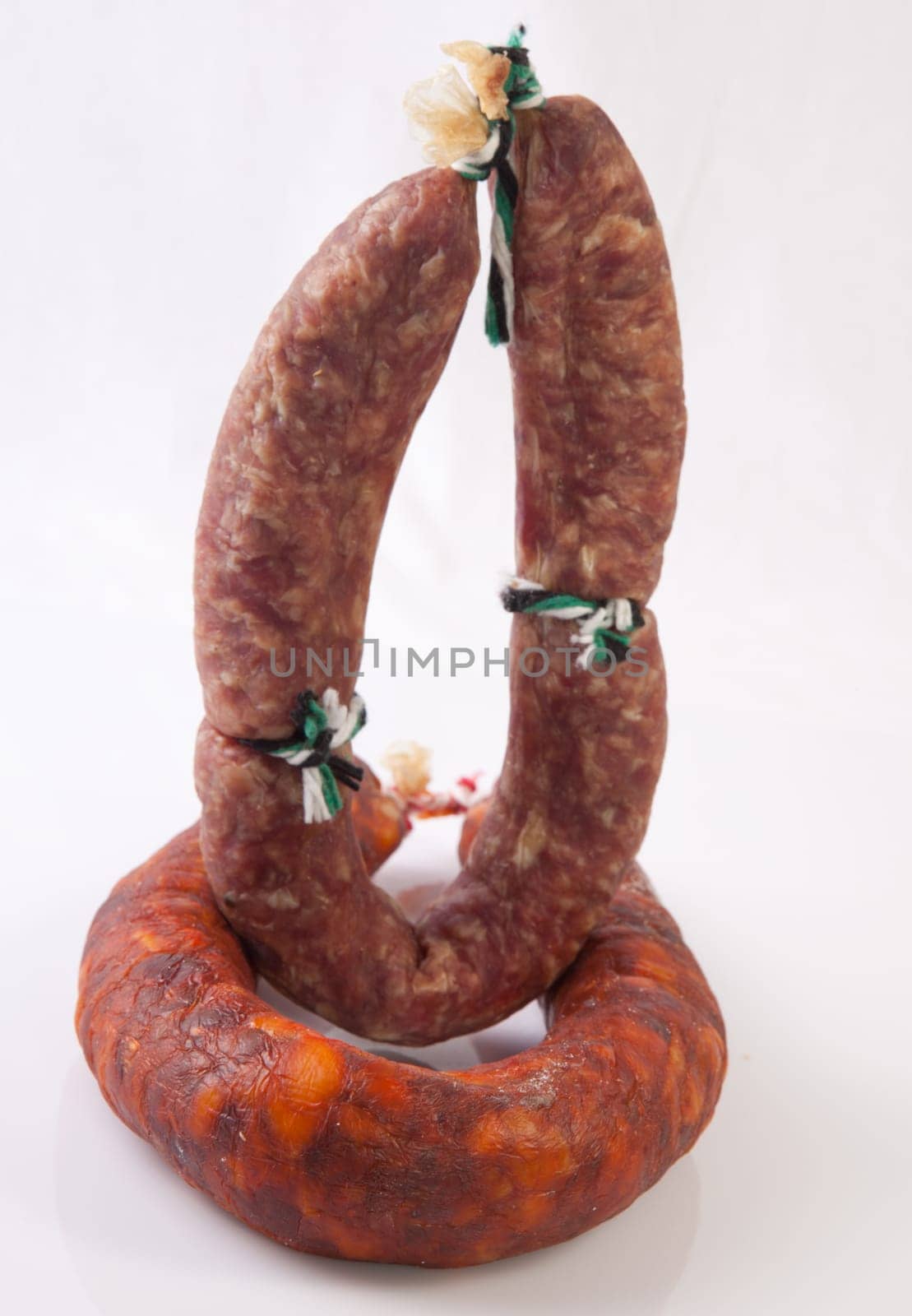 Red and white iberian salchichon. Isolated over white background