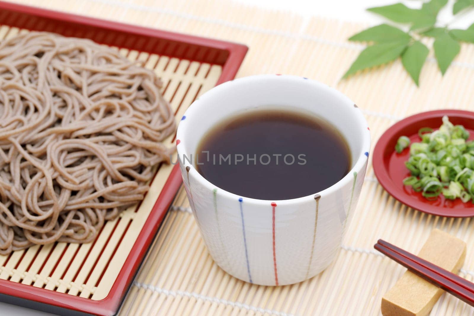 Japanese Zaru soba noodles in a ceramic bowl on white background