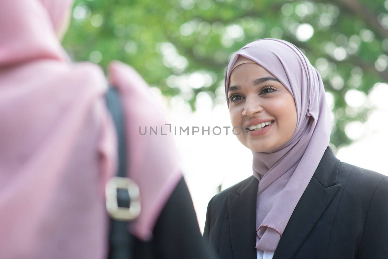 Beautiful Muslim business woman talking and smile.