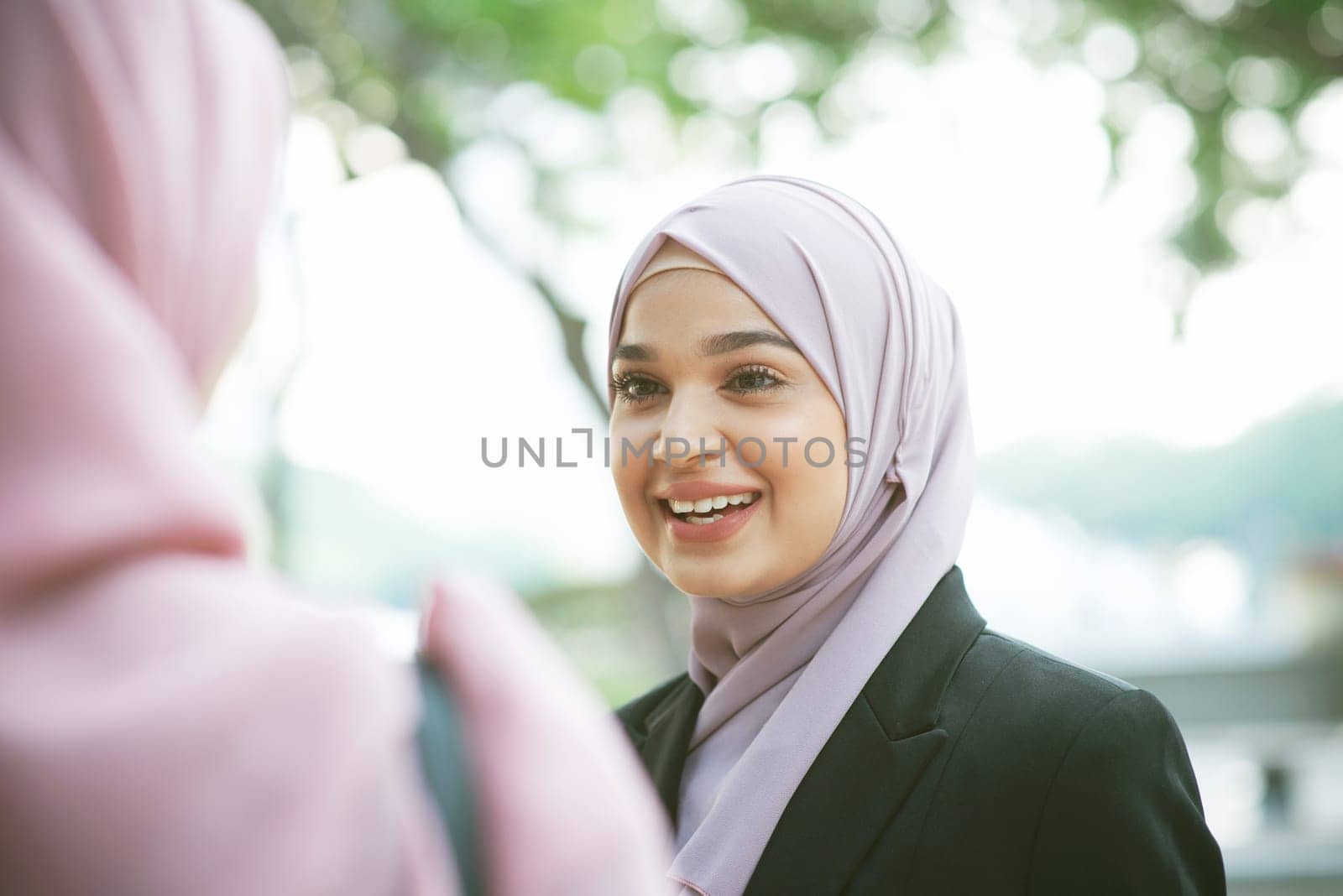 Beautiful Muslim business woman talking and smile.