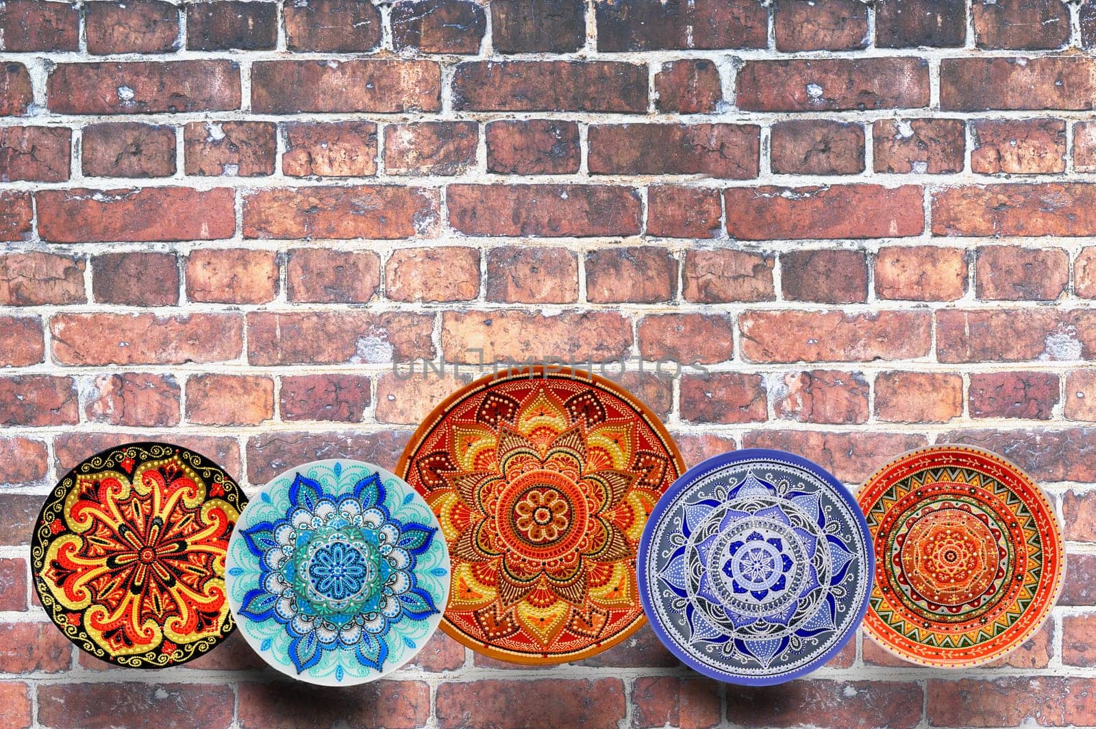 Decorative ceramic dish painted with hands. Art, handmade. Pattern mandala