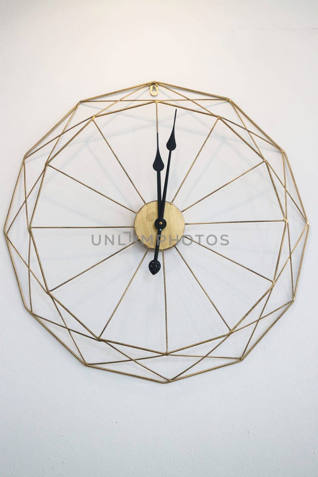 Vintage clock on white wall background, stock photo