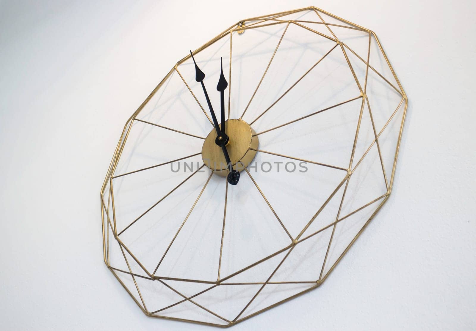 Vintage clock on white wall background, stock photo