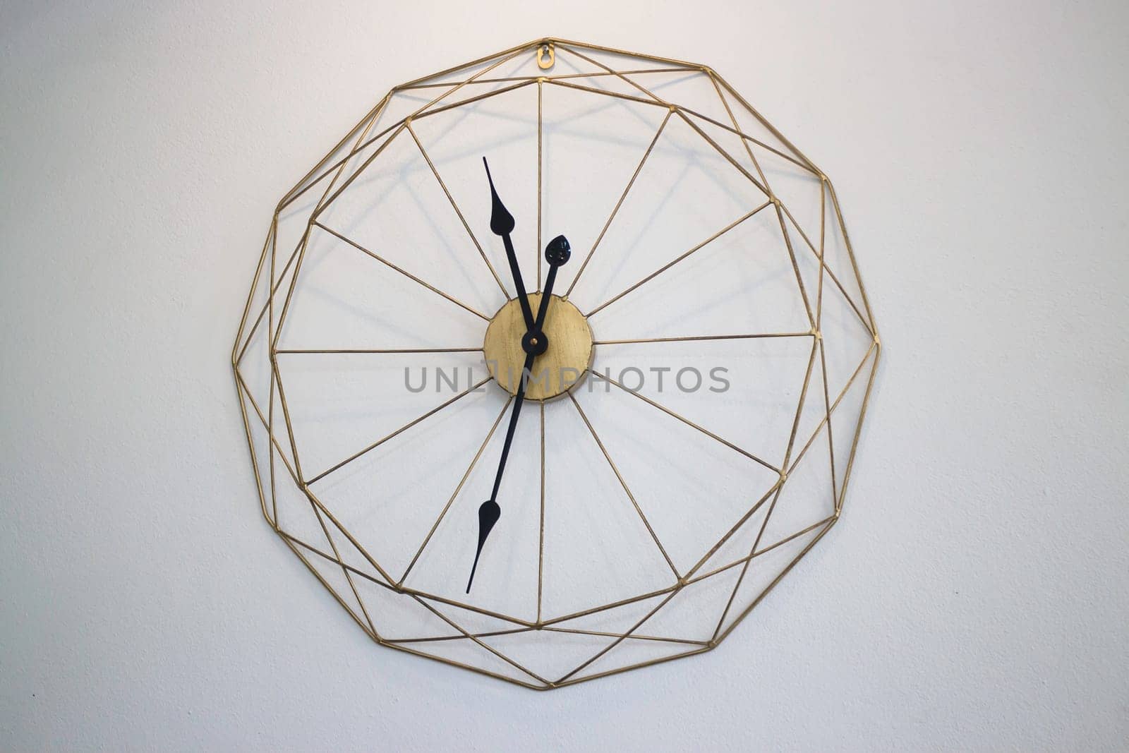 Vintage clock on white wall background, stock photo