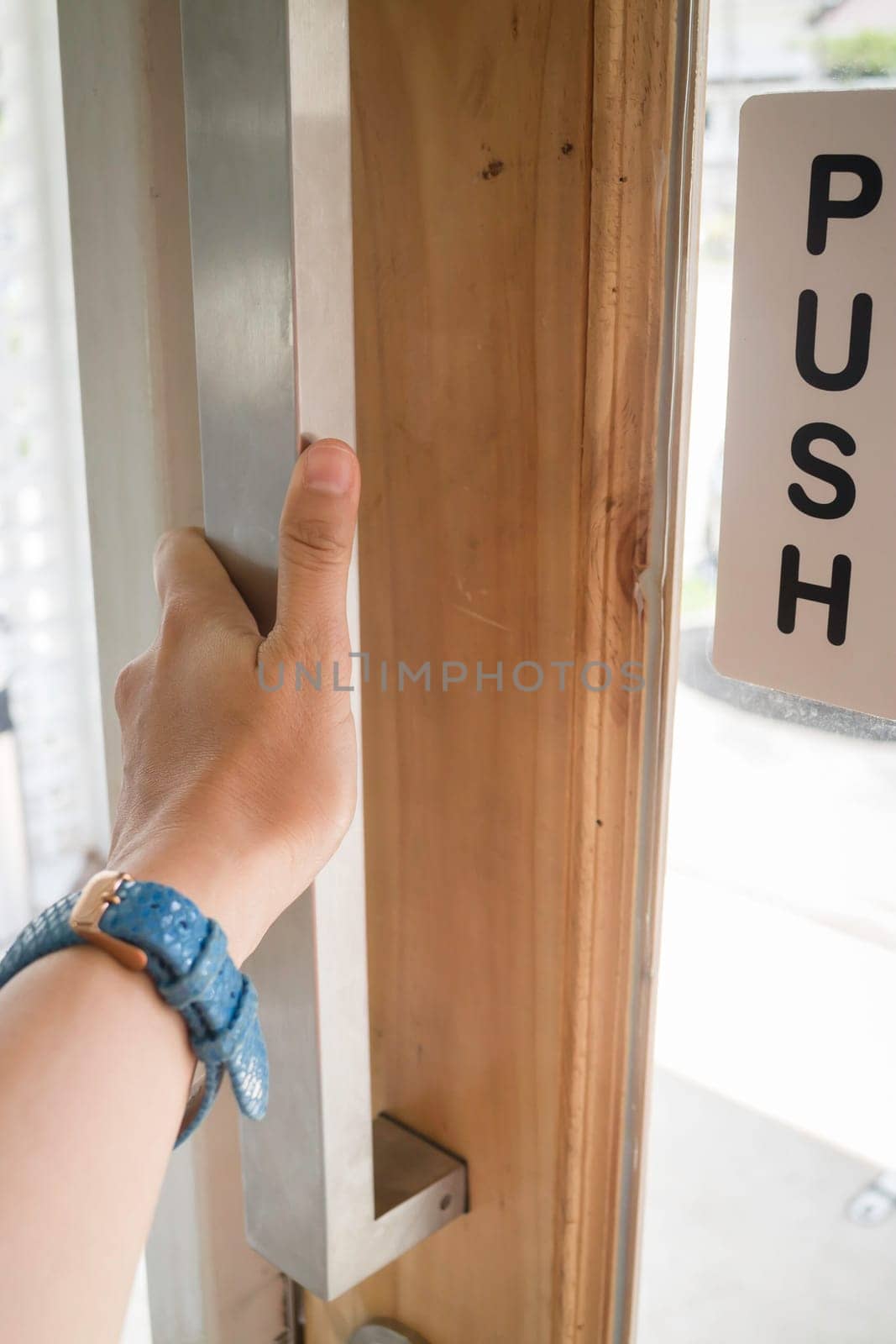 Woman hand opening see through door, stock photo