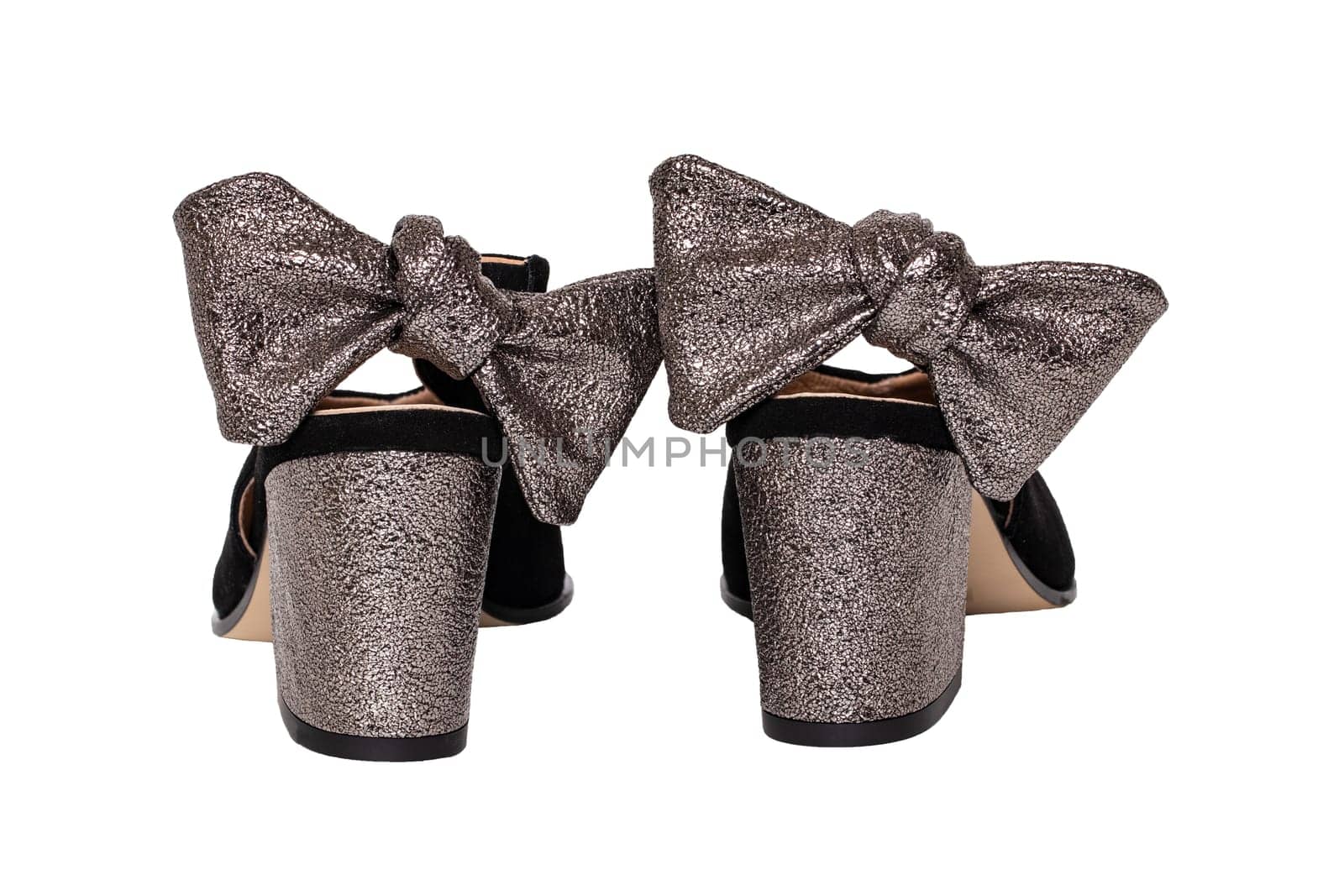Leather shoes isolated. Close-up of a pair of elegant female suede shoes decorated with silver bows isolated on a white background. Shoe fashion 2019. Macro back view.