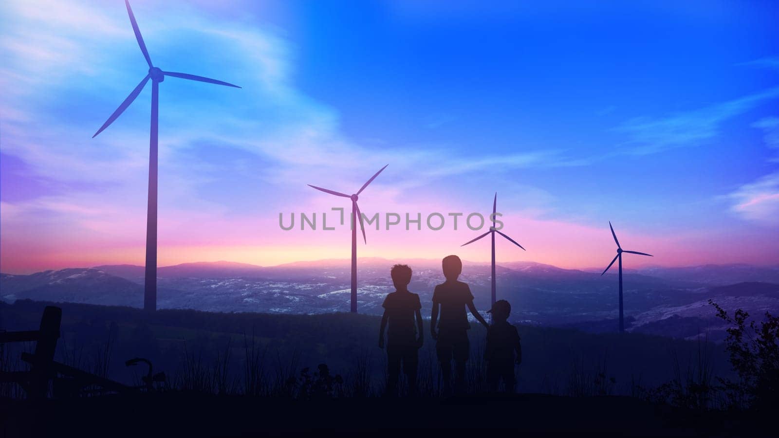 Silhouettes of children standing against the sun at sunset opposite windmill power plants.