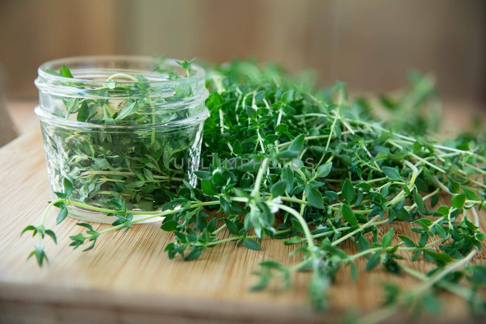 Fresh thyme and glass canning jar for pickled thyme.