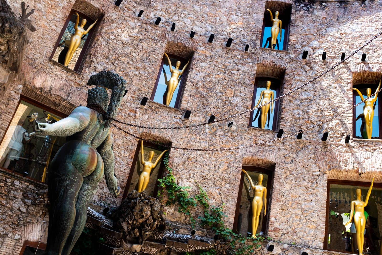 The surrealistic Museum of Salvador Dalì, details from main courtyard: a statue of a shapely woman with chains standing in the stage of the theater.