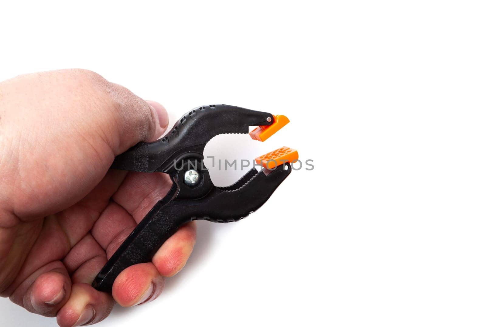 Plastic clips for connecting parts in male hand isolated on white background