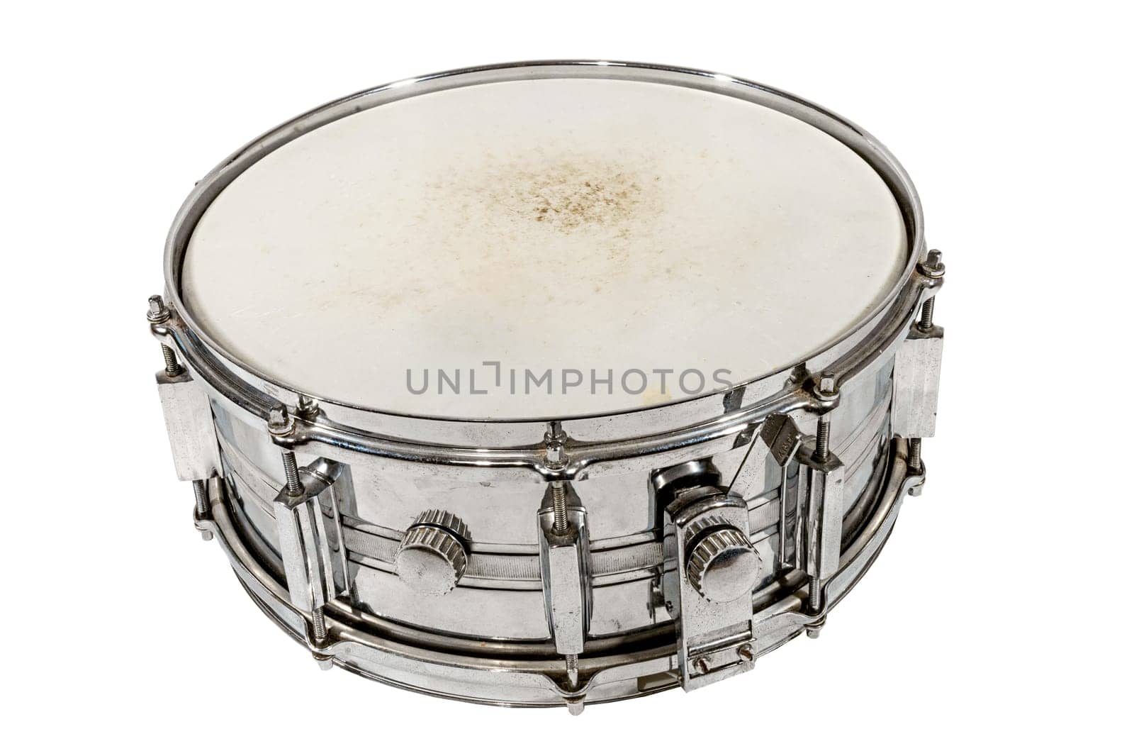 Old silver Snare drum stands on the ground isolated on white
