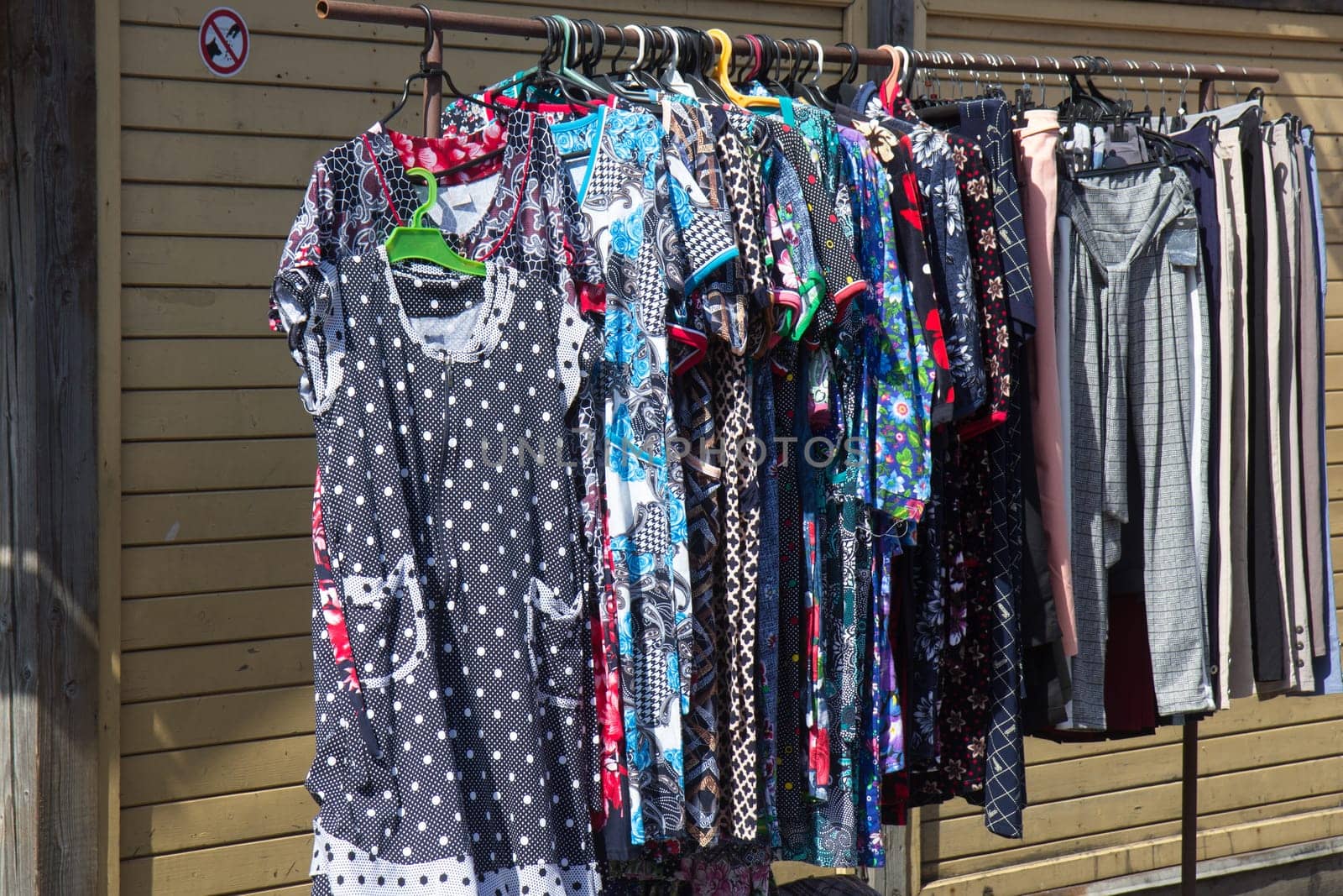 various clothing hung in sale on flea market