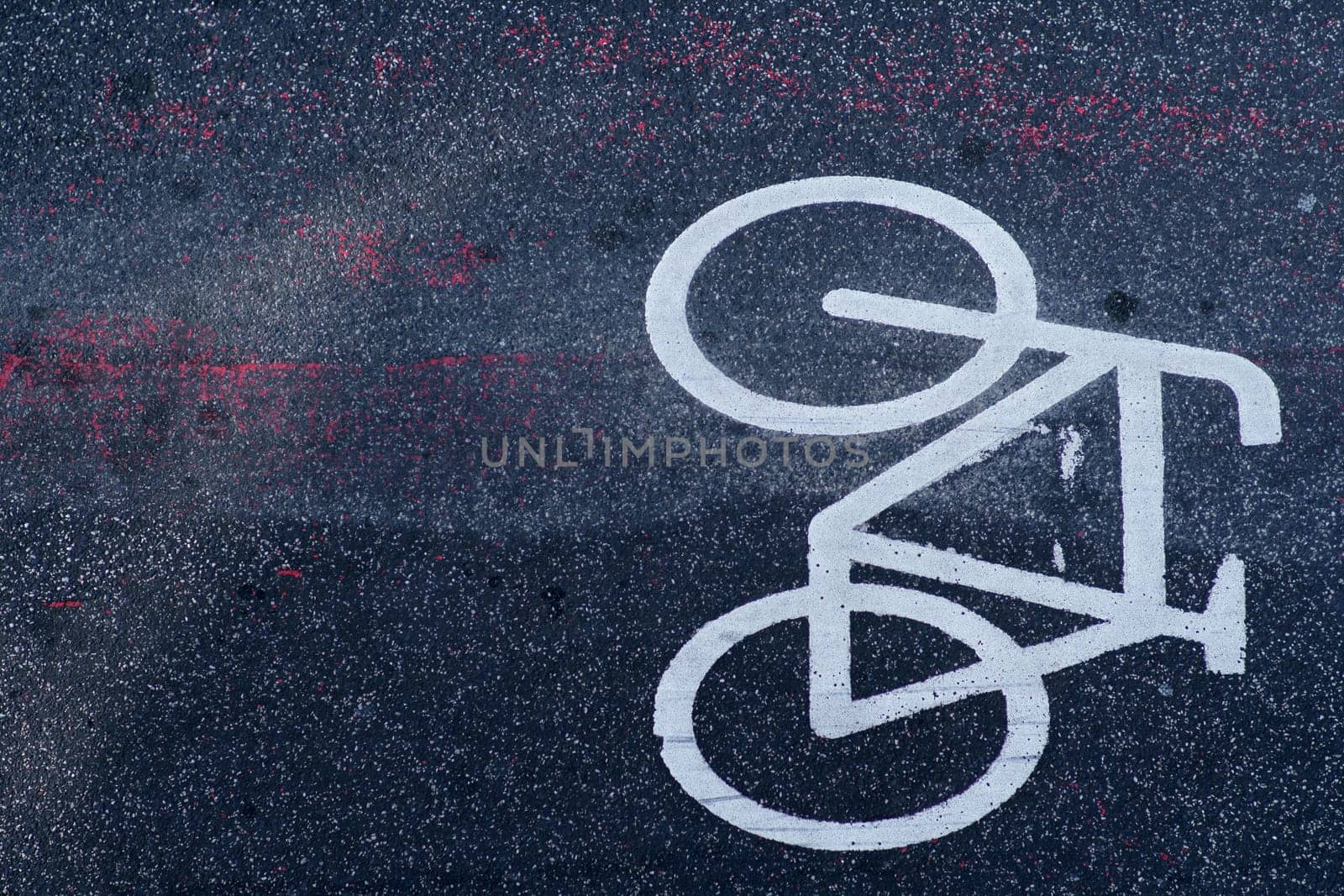 The top view on the road marking and the symbol of a bicycle lane on the asphalt...