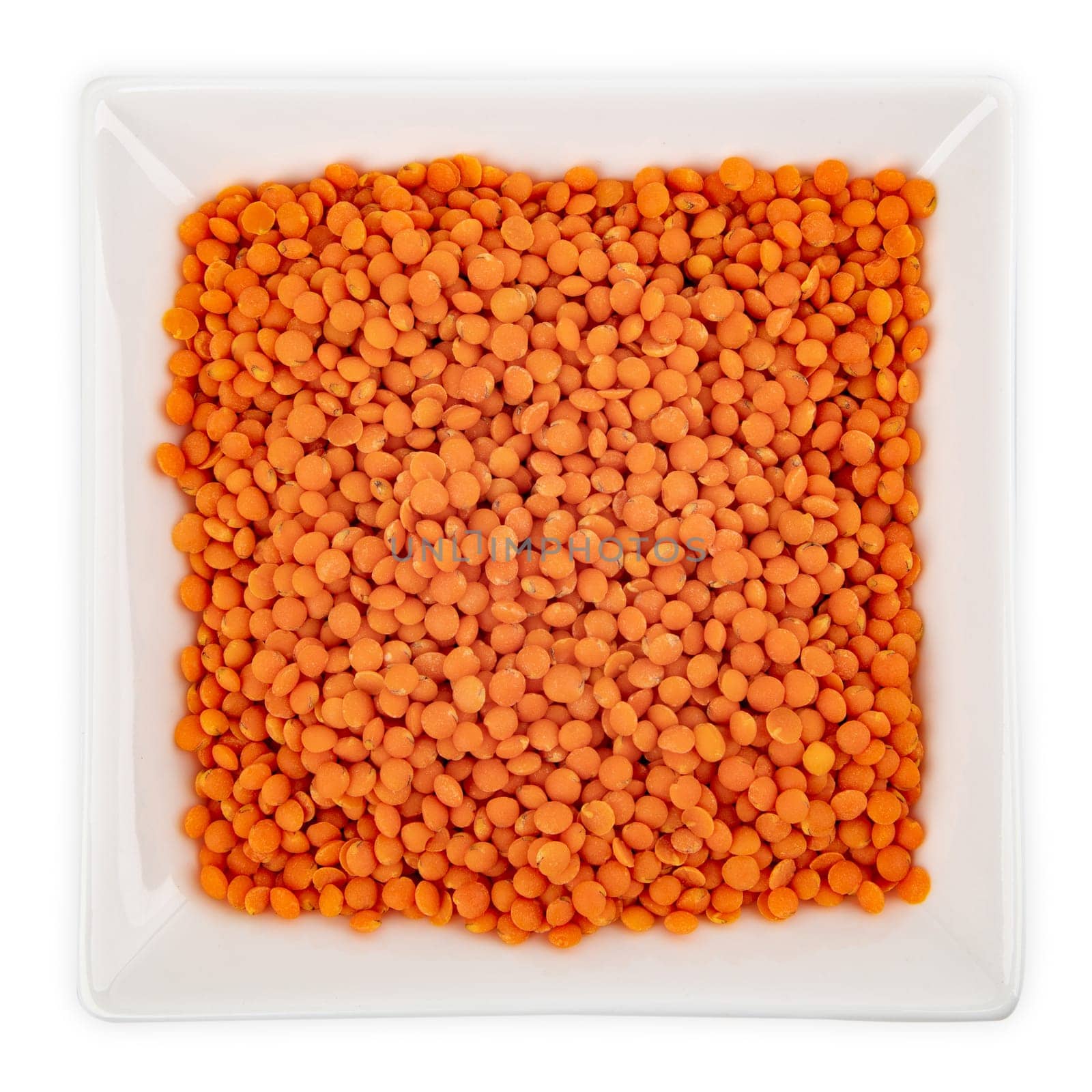 Red Lentils in a bowl isolated on white background