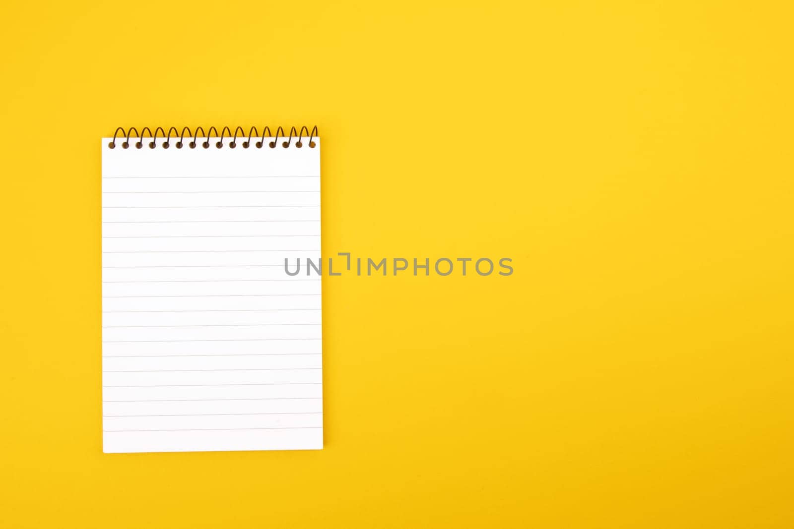 Top View Paper Notepad on yellow cardboard