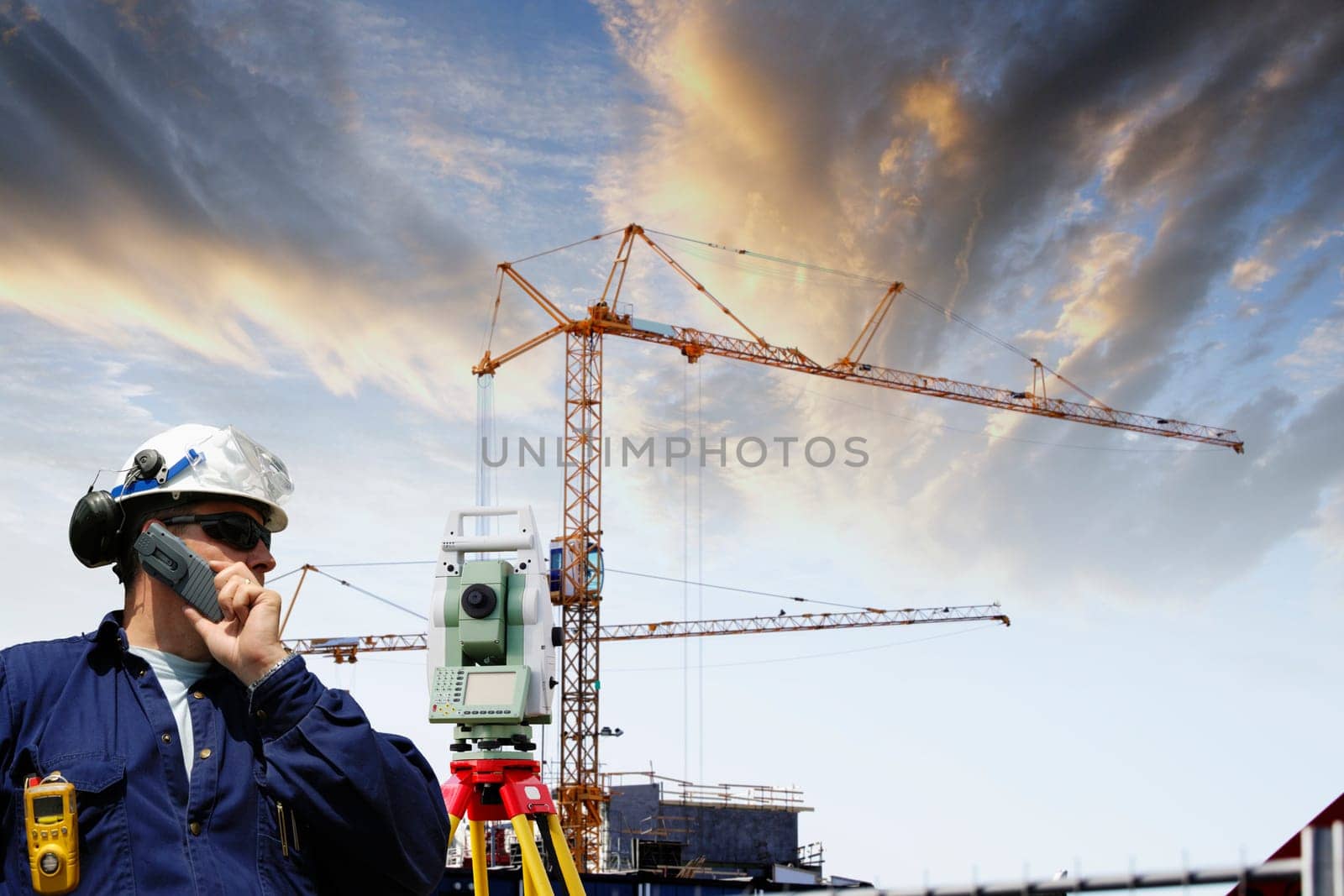 surveyor with measuring-instrument, level and distance measuring inside construction industry