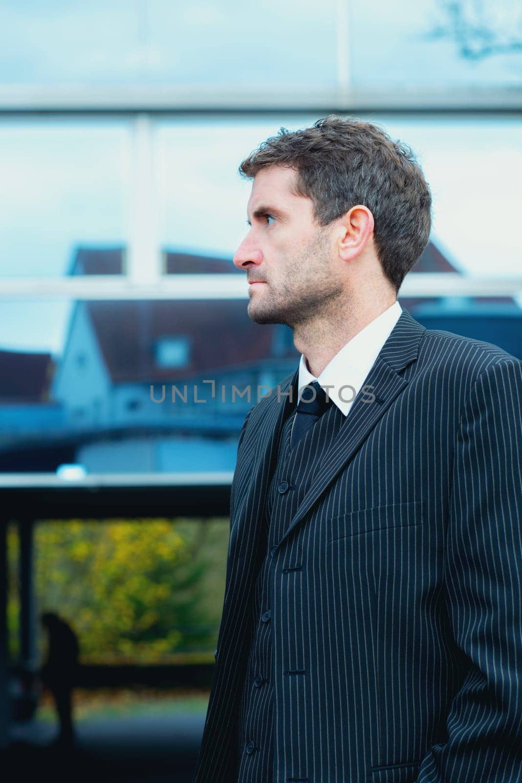 businessman in suit in front of city- background