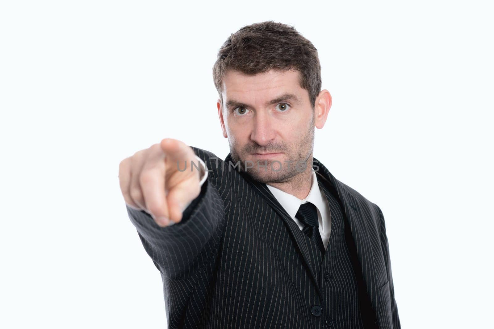businessman in suit is pointing in to the camera