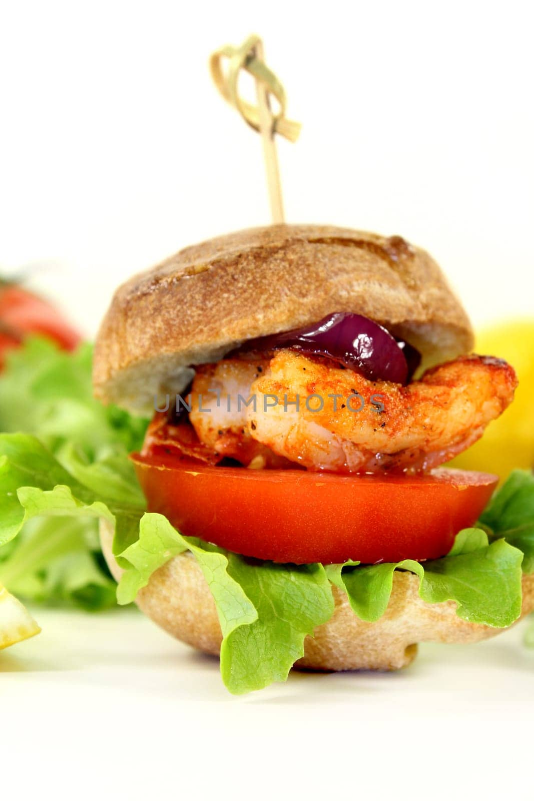Shrimp burger with tomato,red onion and salad