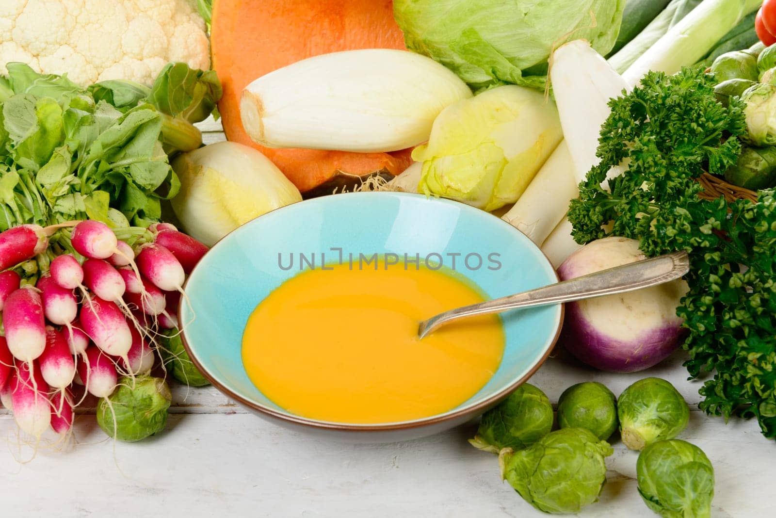 plate of pumpkin soup with  several vegetables