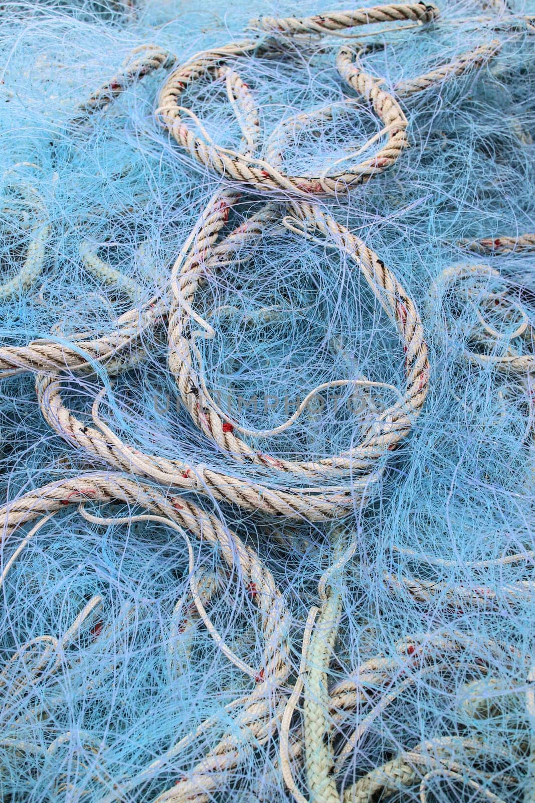 Background made from blue fishing nets and ropes